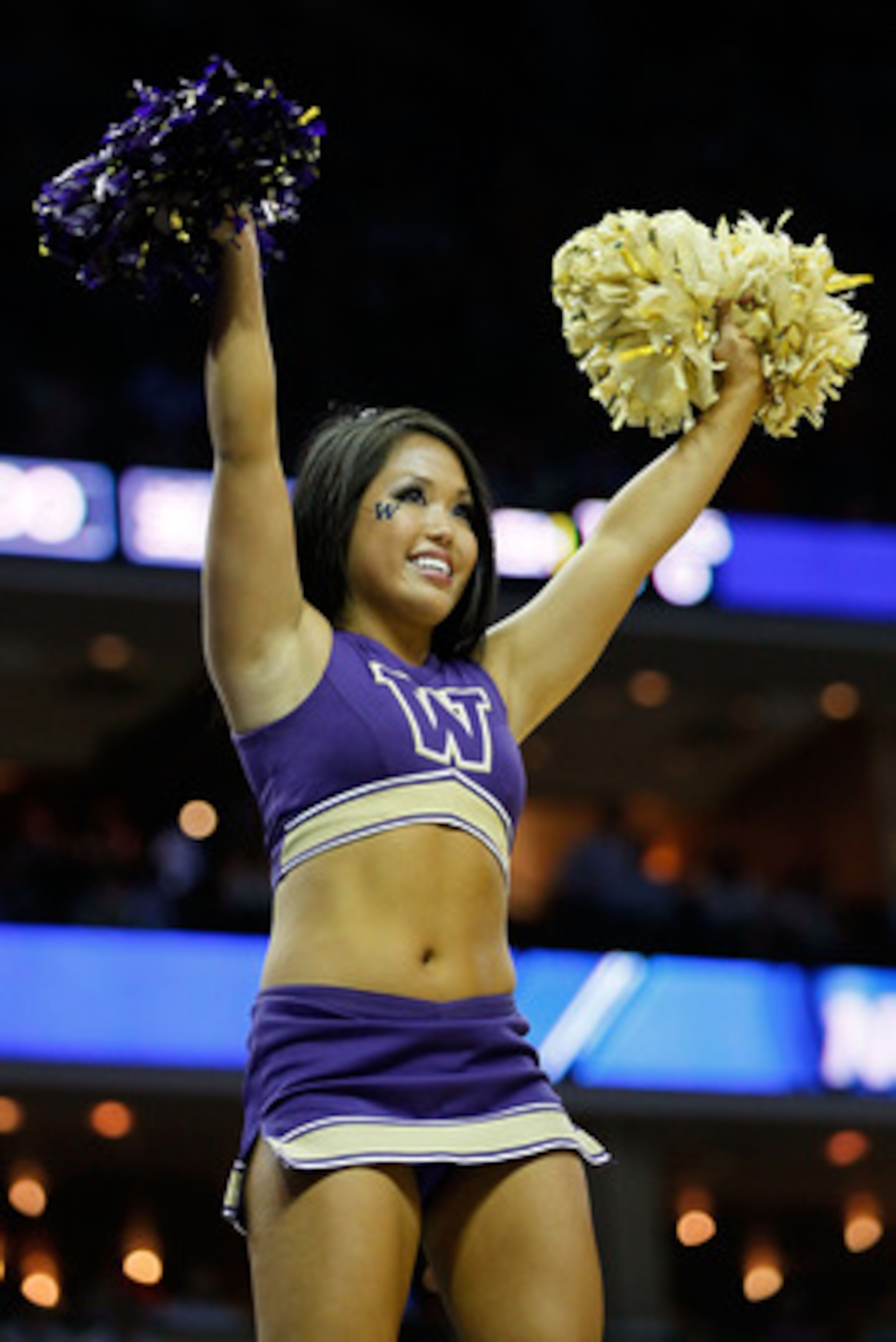 CHARLOTTE, NC - MARCH 18:  A Washington Huskies cheerleader performs while the Huskies take on the Georgia Bulldogs during the second round of the 2011 NCAA men's basketball tournament at Time Warner Cable Arena on March 18, 2011 in Charlotte, North Carol