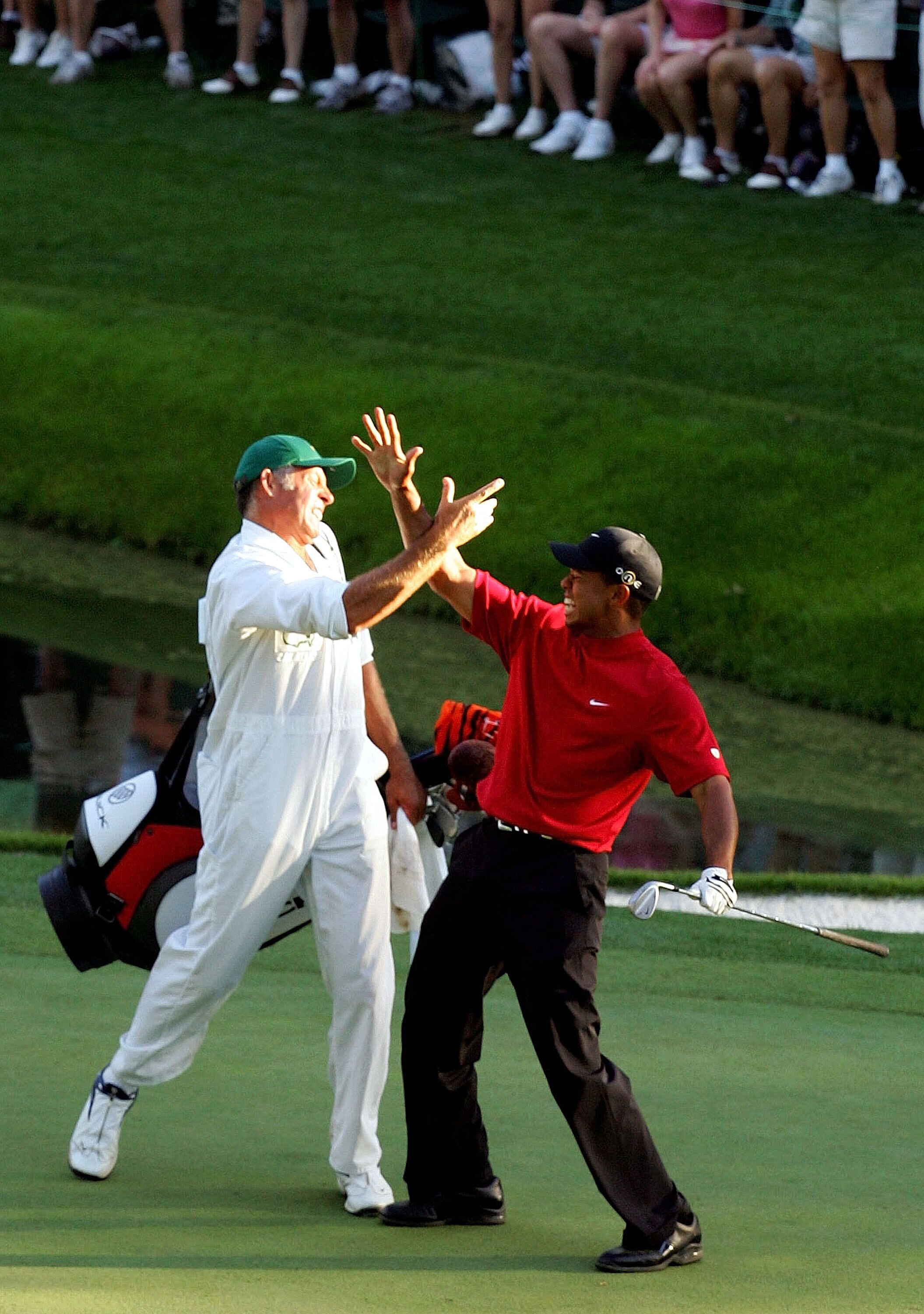 AUGUSTA, GA - APRIL 10:  Tiger Woods and his caddie, Steve Williams, celebrate after Woods chipped in for birdie on the 16th hole during the final round of The Masters at the Augusta National Golf Club on April 10, 2005 in Augusta, Georgia.  (Photo by Har