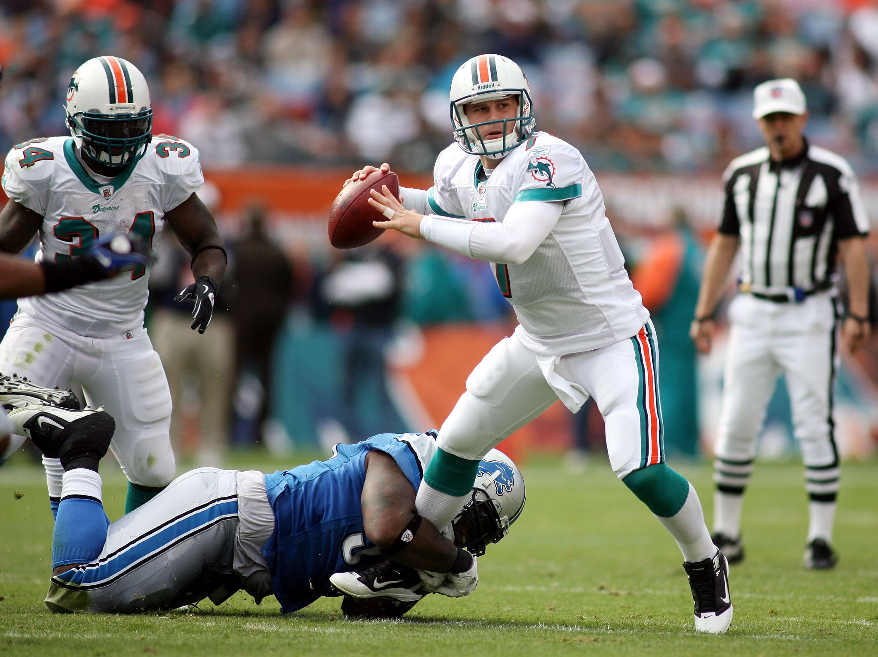 MIAMI - DECEMBER 26:  Quarterback Chad Henne #7 of the Miami Dolphins is preasured by Lawrence Jackson #94 of the Detroit Lions at Sun Life Stadium on December 26, 2010 in Miami, Florida.  (Photo by Marc Serota/Getty Images)