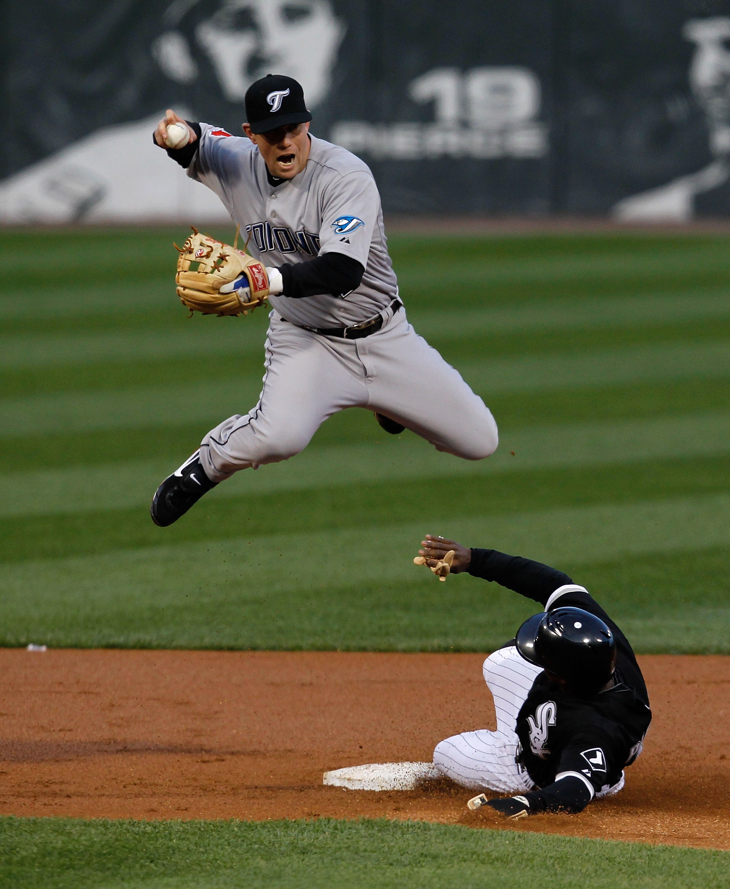 CHICAGO - MAY 06: Juan Pierre #1 of the Chicago White Sox slides into second base and forces Aaron Hill #2 of the Toronto Blue Jays to leap and miss the double-play relay throw at U.S. Cellular Field on May 6, 2010 in Chicago, Illinois. (Photo by Jonathan