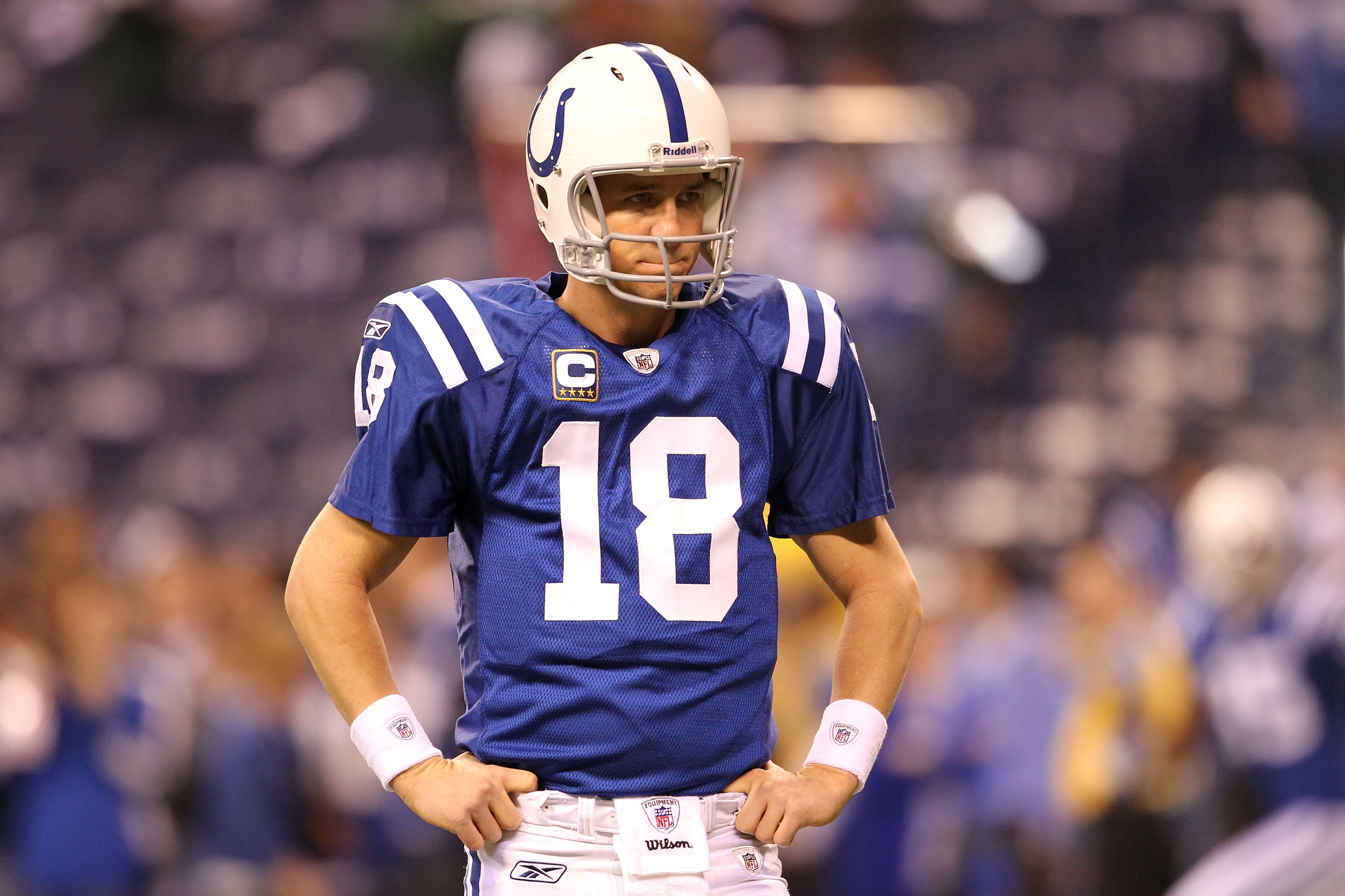 INDIANAPOLIS, IN - JANUARY 08:  Quarterback Peyton Manning #18 of the Indianapolis Colts looks on during warm ups against the New York Jets during their 2011 AFC wild card playoff game at Lucas Oil Stadium on January 8, 2011 in Indianapolis, Indiana.  (Ph