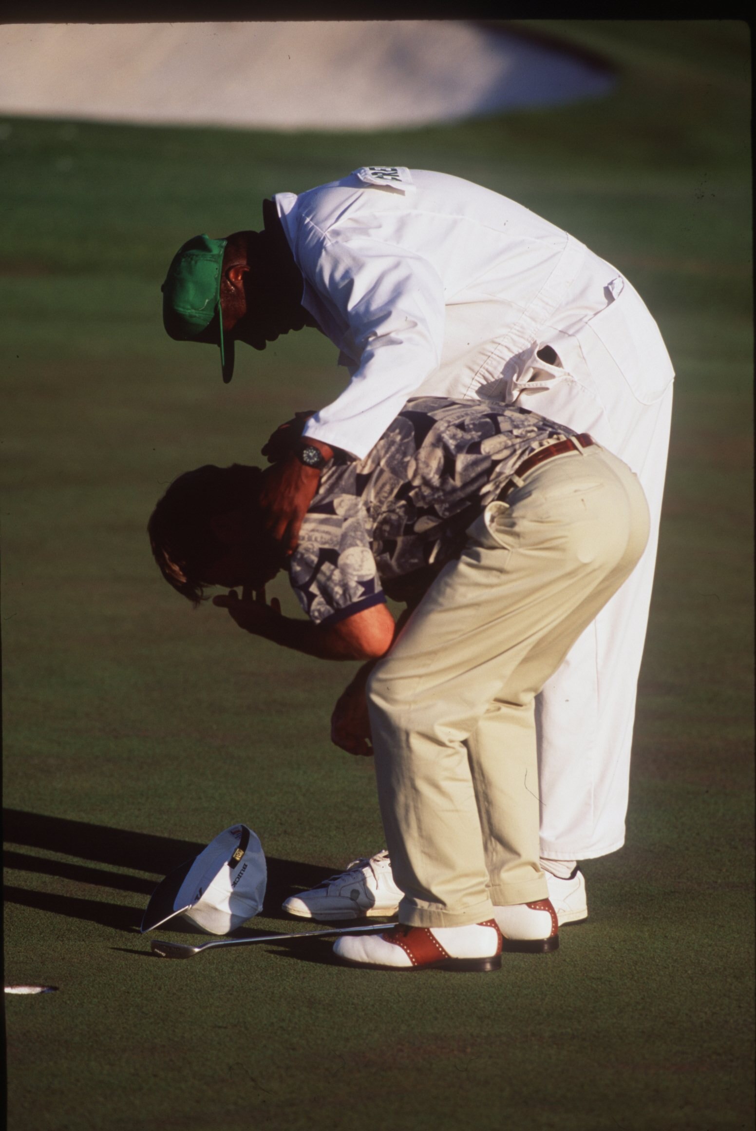 9 APR 1995:  AN EMOTONAL BEN CRENSHAW OF THE USA IS CONGRATULATED BY HIS CADDIE ON THE 18TH GREEN AFTER WINNING THE 1995 US MASTERS GOLF CHAMPIONSHIP AT THE AUGUSTA NATIONAL GOLF COURSE IN AUGUSTA, GEORGIA. Mandatory Credit: Steve Munday/ALLSPORT