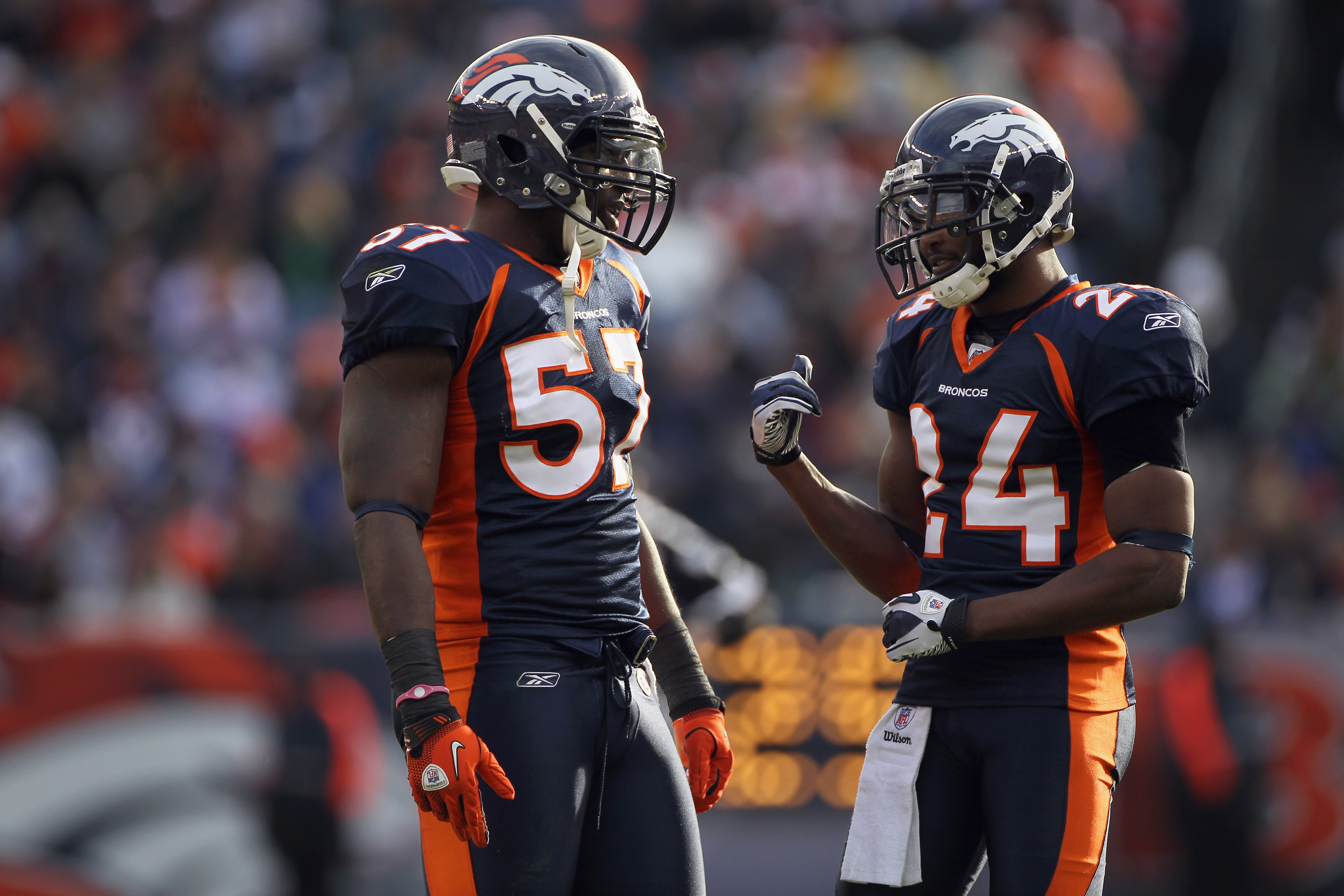 DENVER - DECEMBER 26:  Linebacker Mario Haggen #57 and cornerback Champ Bailey #24 of the Denver Broncos talk during a break in the action against the Houston Texans at INVESCO Field at Mile High on December 26, 2010 in Denver, Colorado. The Broncos defea