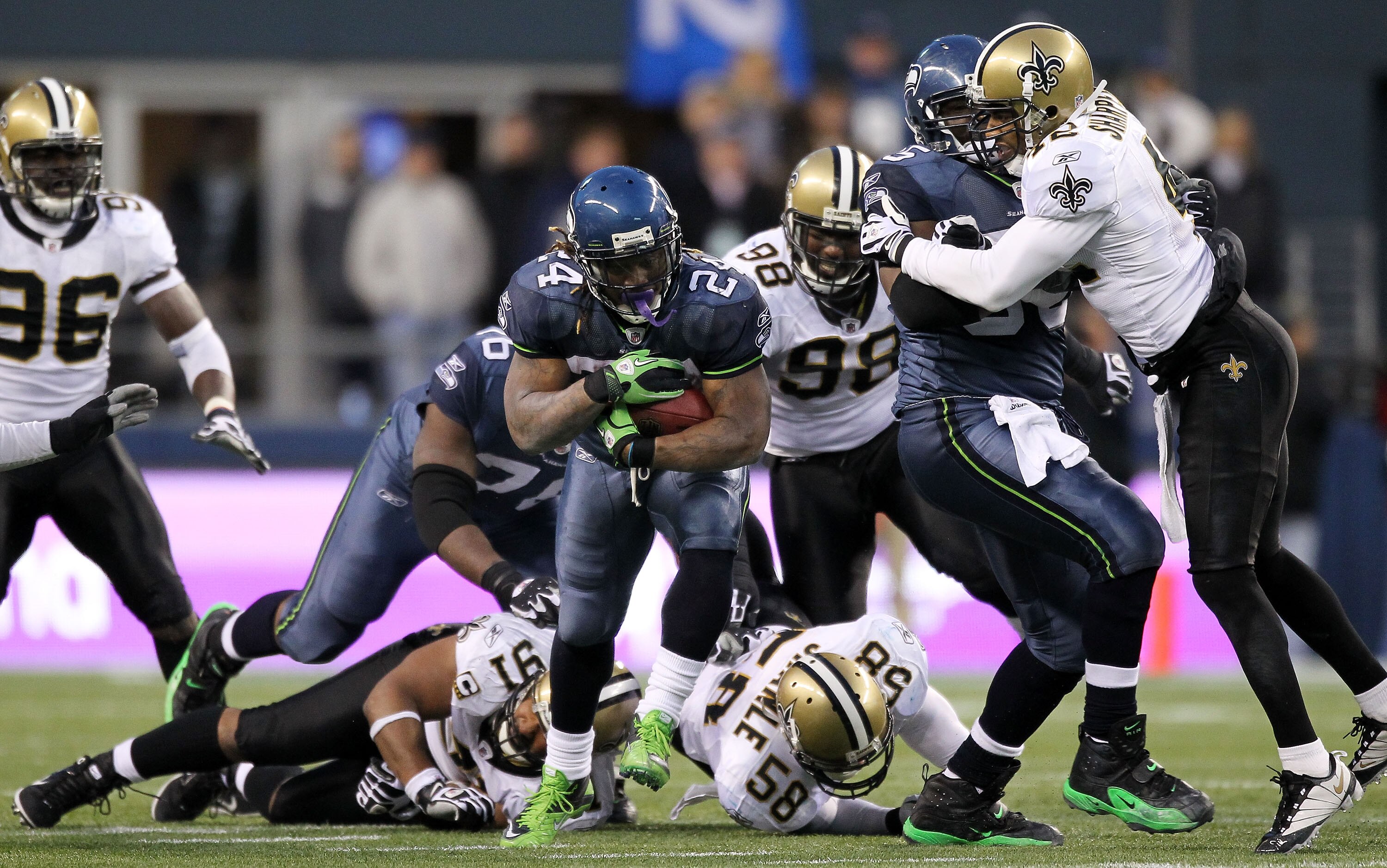 SEATTLE, WA - JANUARY 08:  Running back Marshawn Lynch #24 of the Seattle Seahawks runs for a 67-yard touchdown run in the fourth quarter against the New Orleans Saints during the 2011 NFC wild-card playoff game at Qwest Field on January 8, 2011 in Seattl