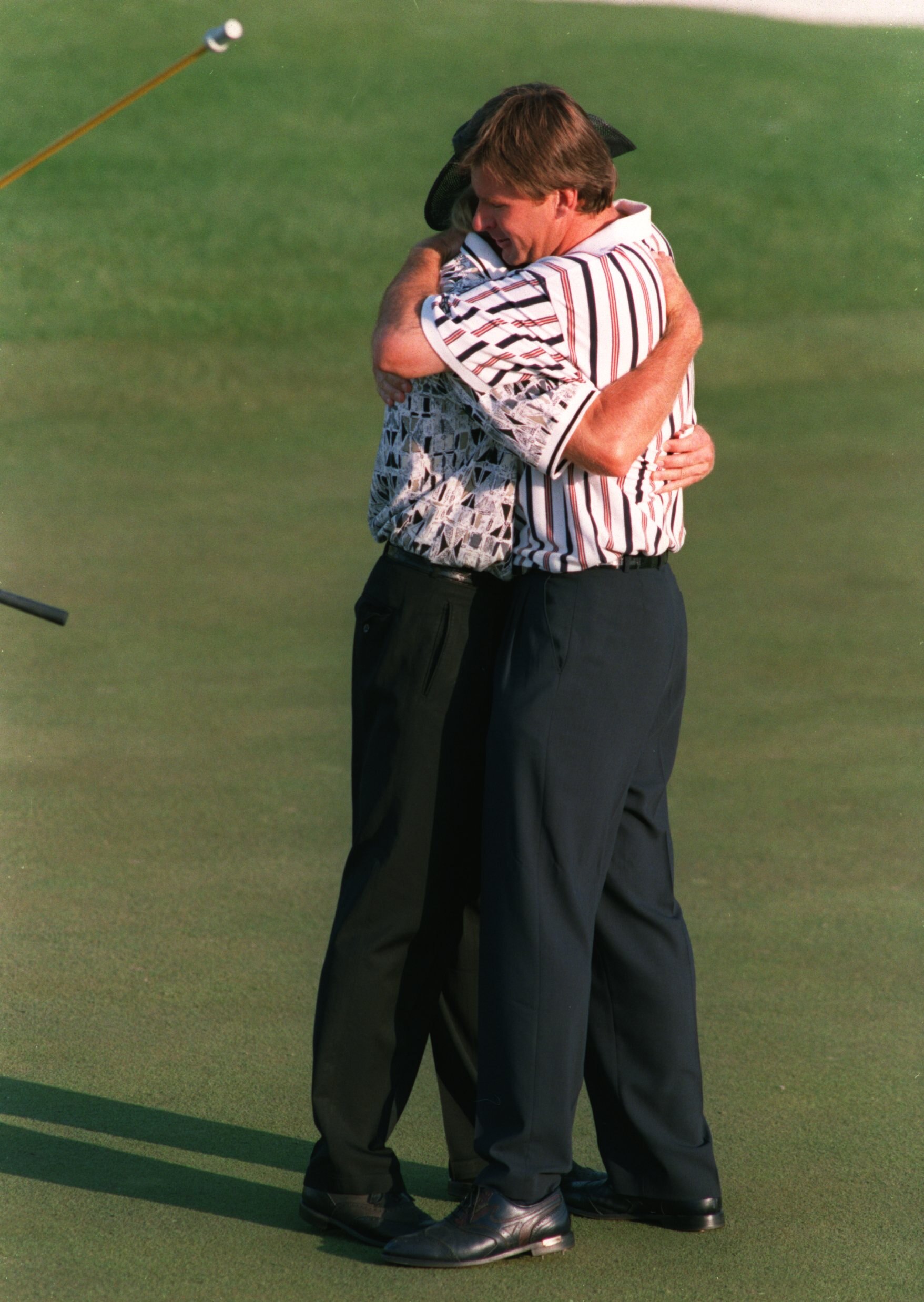 14 Apr 1996 :  Nick Faldo of England is congratulated by runner-up Greg Norman of Australia after holing his final putt on the 18th green for victory in the 1996 US Masters Golf Championship at the Augusta National Golf Club in Augusta, Georgia. Mandatory