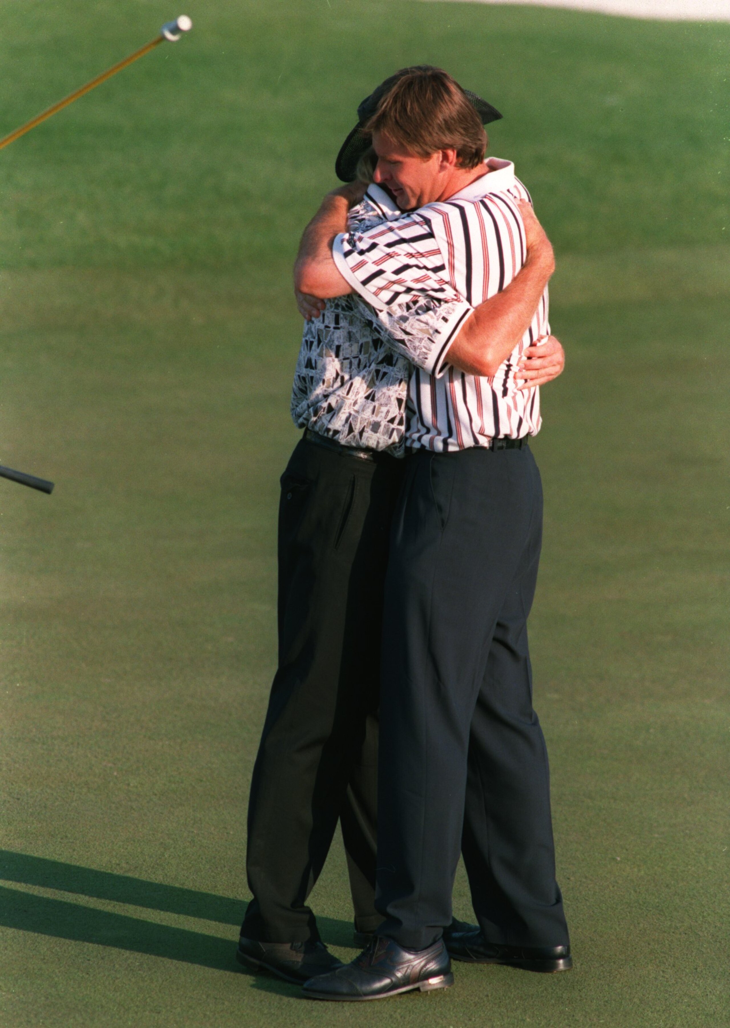 14 Apr 1996 :  Nick Faldo of England is congratulated by runner-up Greg Norman of Australia after holing his final putt on the 18th green for victory in the 1996 US Masters Golf Championship at the Augusta National Golf Club in Augusta, Georgia. Mandatory