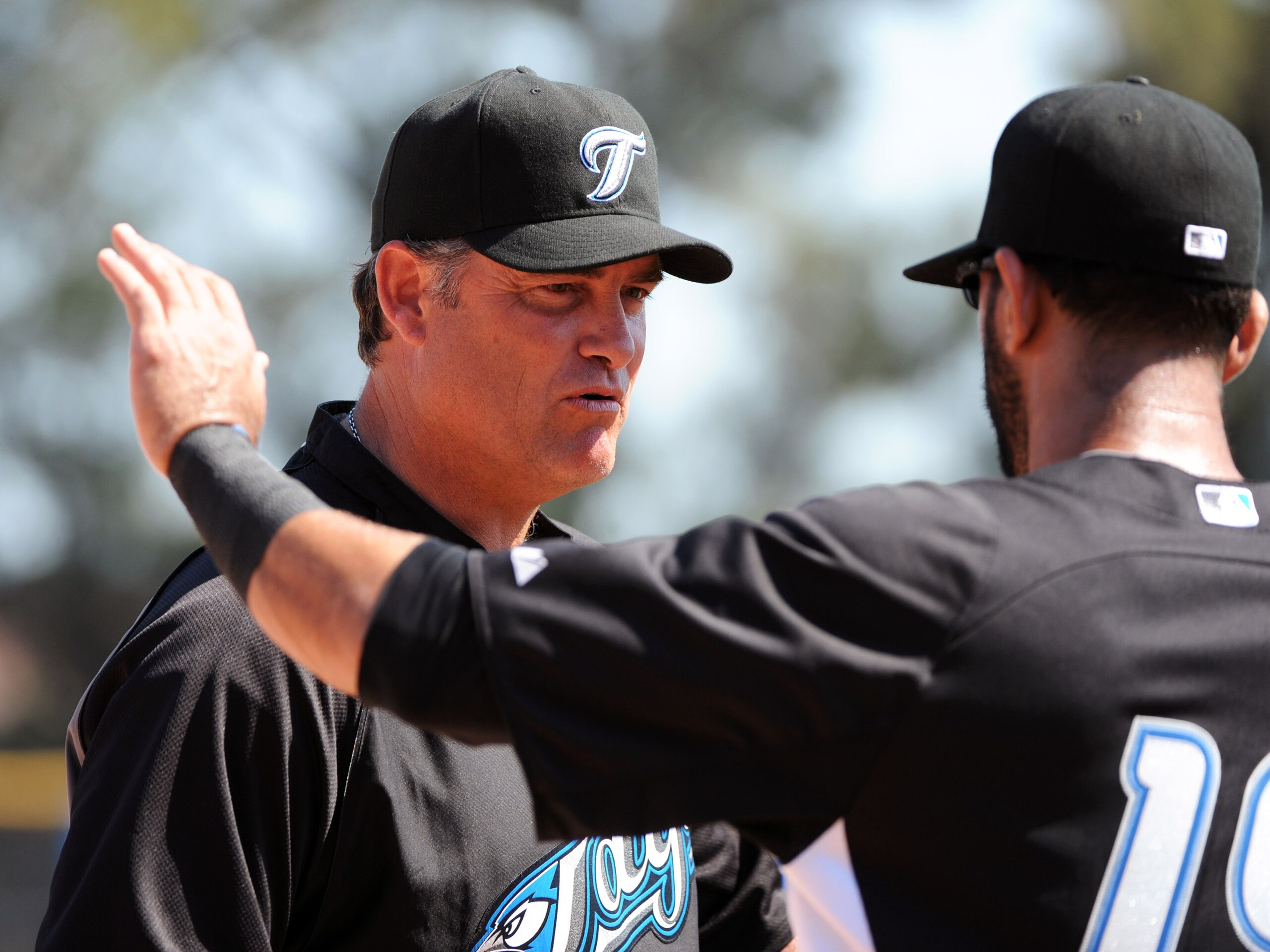 DUNEDIN, FL - FEBRUARY 26:  Manager John Farrell #52 talks with catcher J. P. Arencibia #9 of the Toronto Blue Jays before play against the Detroit Tigers February 26, 2011 at Florida Auto Exchange Stadium in Dunedin, Florida.  (Photo by Al Messerschmidt/