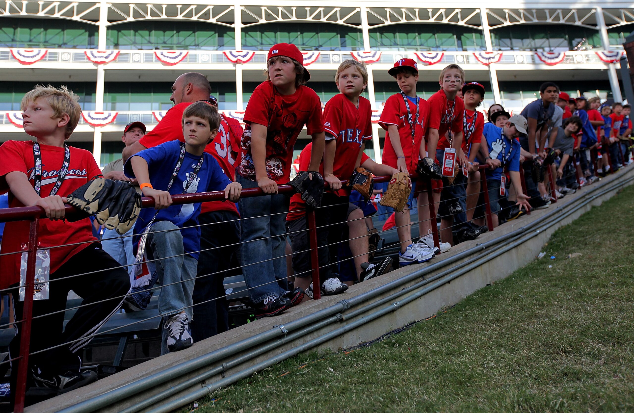 ARLINGTON, TX - NOVEMBER 01:  Fans attempt to catch home run balls during batting practice prior to the Texas Rangers playing against the San Francisco Giants in Game Five of the 2010 MLB World Series at Rangers Ballpark in Arlington on November 1, 2010 i