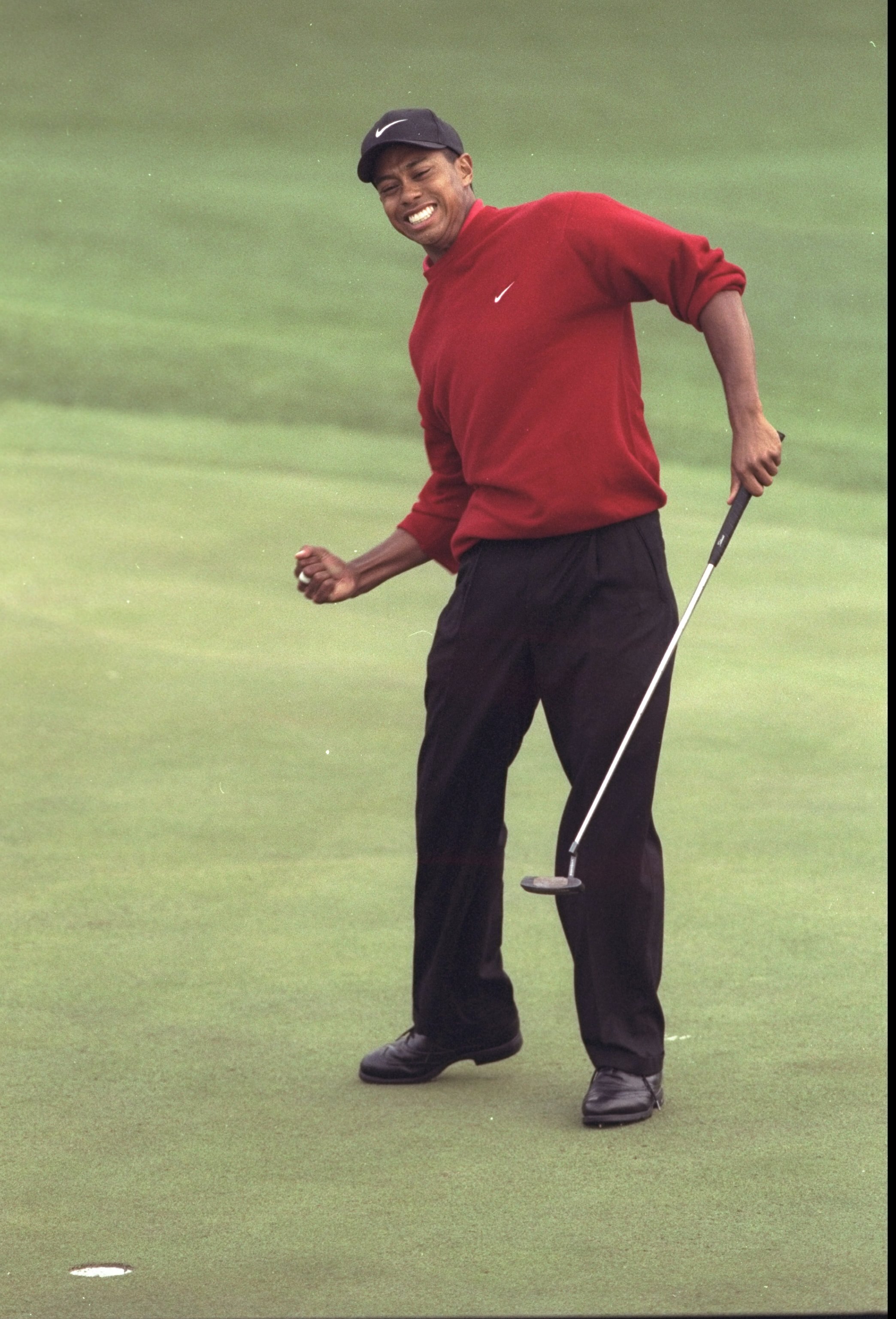 13 Apr 1997: Tiger Woods of the USA celebrates victory in the US Masters at Augusta, Georgia. Woods won the tournament with a record low score of 18 under par. \ Mandatory Credit: David Cannon /Allsport