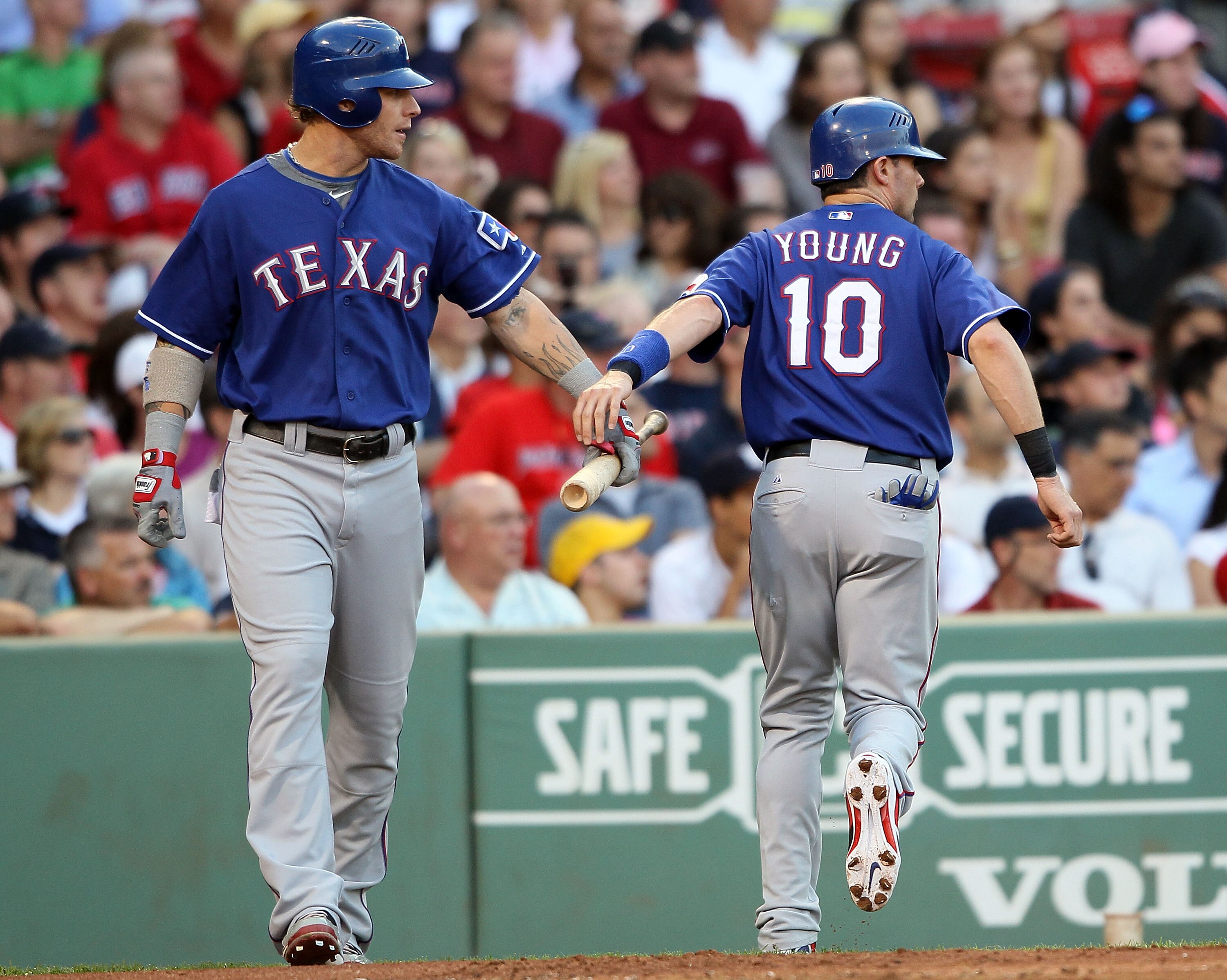 BOSTON - JULY 15:  Josh Hamilton #32 of the Texas Rangers congratulates Michael Young #10 after Young scored in the first inning against the Boston Red Sox on July 15, 2010 at Fenway Park in Boston, Massachusetts.  (Photo by Elsa/Getty Images)