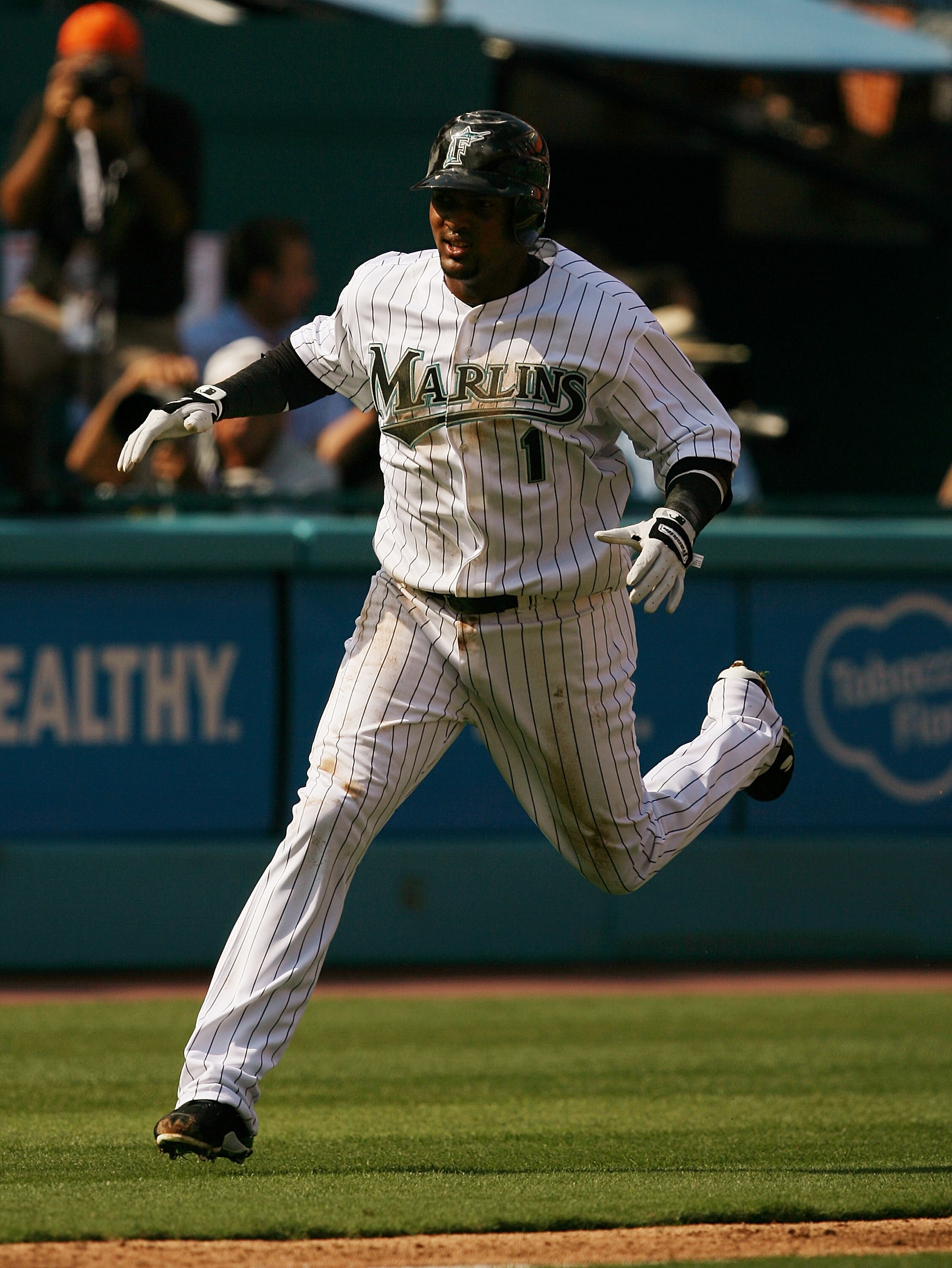 MIAMI - APRIL 06:  Emilio Bonifacio #1 of the Florida Marlins scores on a base hit in the first inning against the Washington Nationals on opening day at Dolphin Stadium on April 6, 2009 in Miami, Florida.  (Photo by Doug Benc/Getty Images)