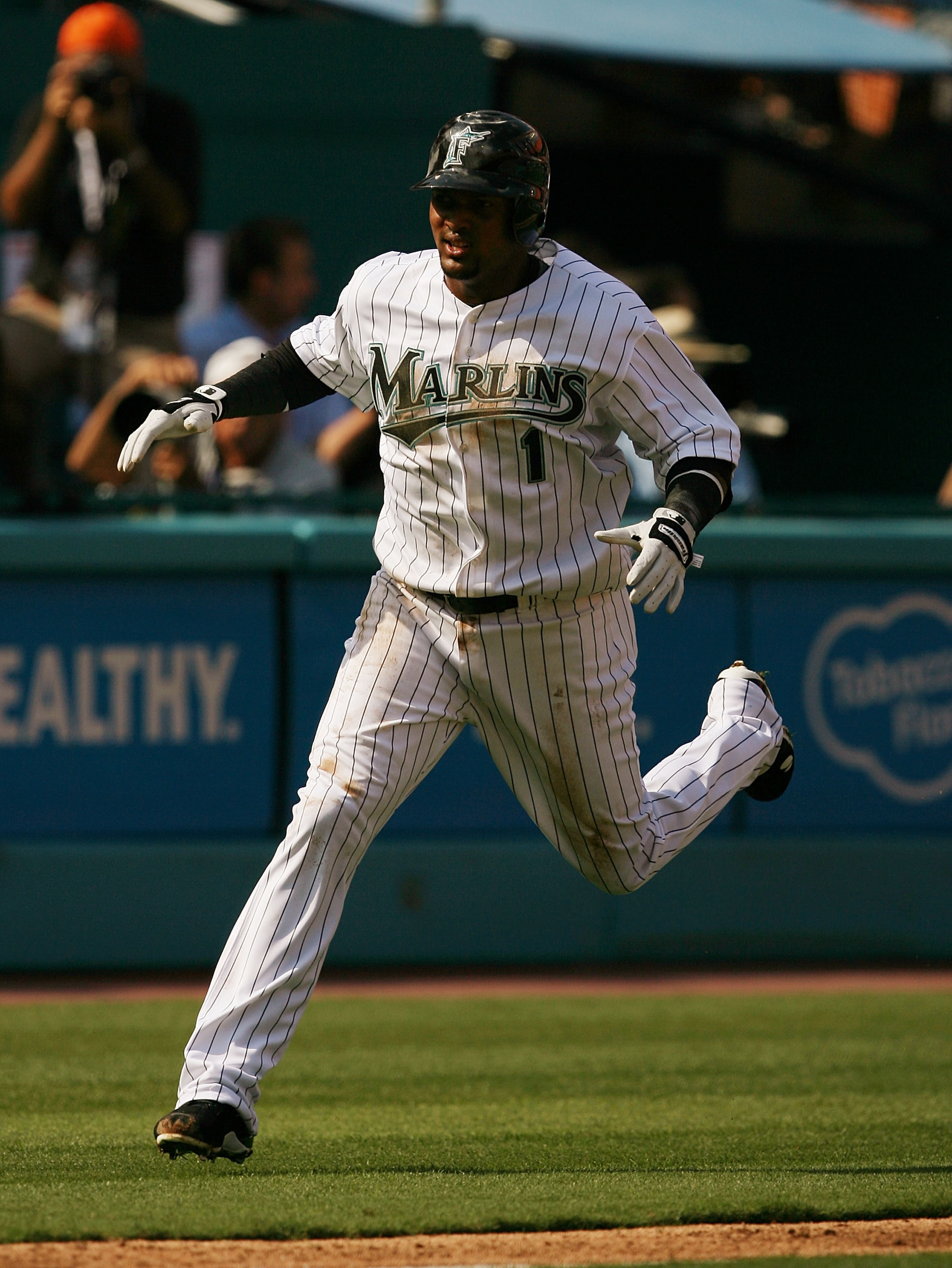 MIAMI - APRIL 06:  Emilio Bonifacio #1 of the Florida Marlins scores on a base hit in the first inning against the Washington Nationals on opening day at Dolphin Stadium on April 6, 2009 in Miami, Florida.  (Photo by Doug Benc/Getty Images)