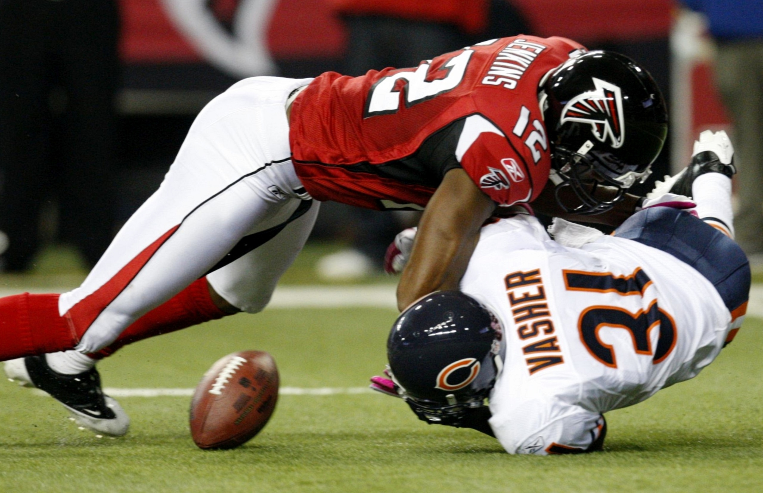 ATLANTA - OCTOBER 18:  Nathan Vasher #31 of the Chicago Bears intercepts the ball but fumbles it under  Michael Jenkins #12 of the Atlanta Falcons in the second half of the game at the Georgia Dome on October 18, 2009 in Atlanta, Georgia. The Falcons won