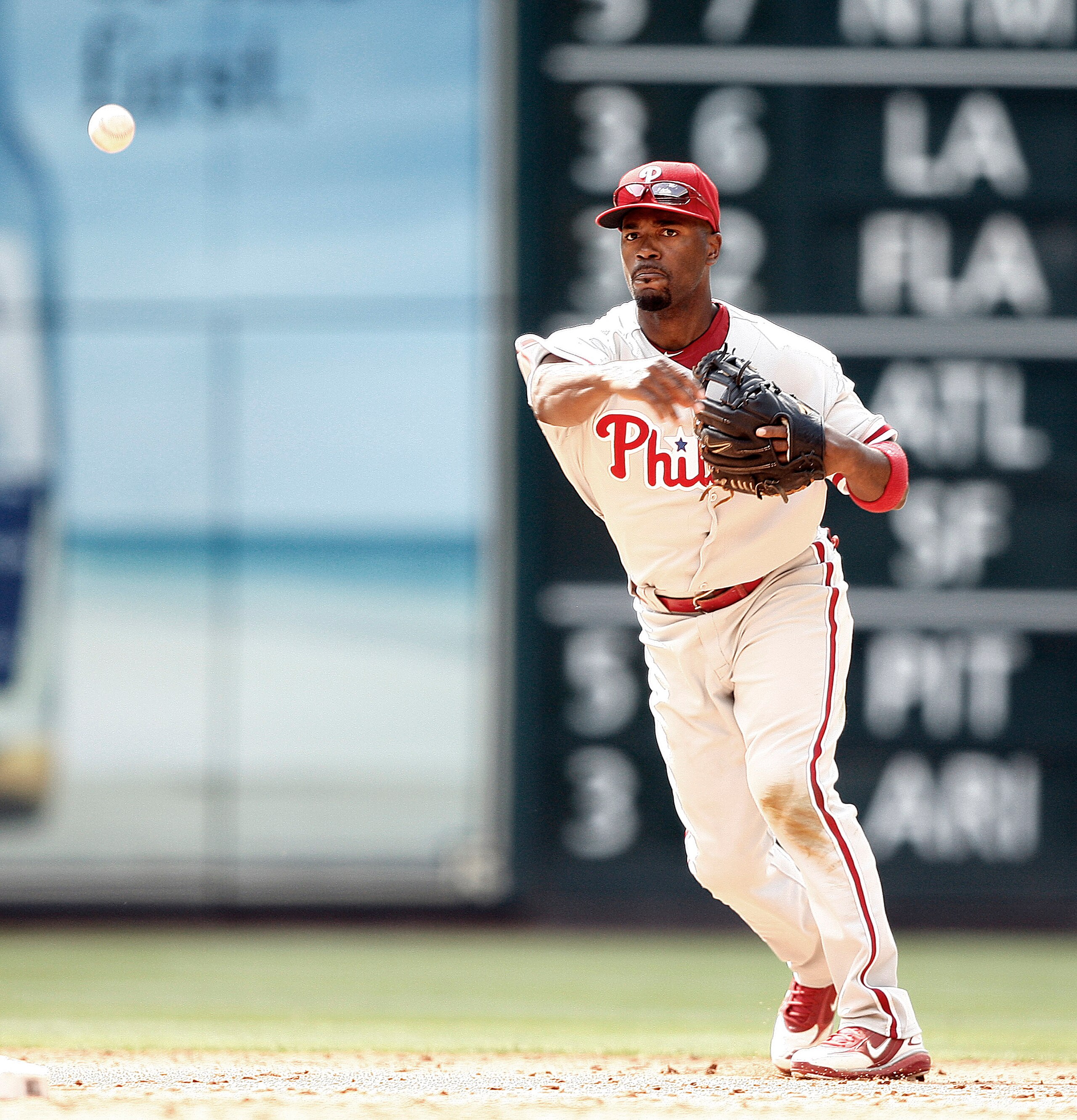 HOUSTON - APRIL 11:  Shortstop Jimmy Rollins #11 of the Philadelphia Phillies throws to first base at Minute Maid Park on April 11, 2010 in Houston, Texas.  (Photo by Bob Levey/Getty Images)