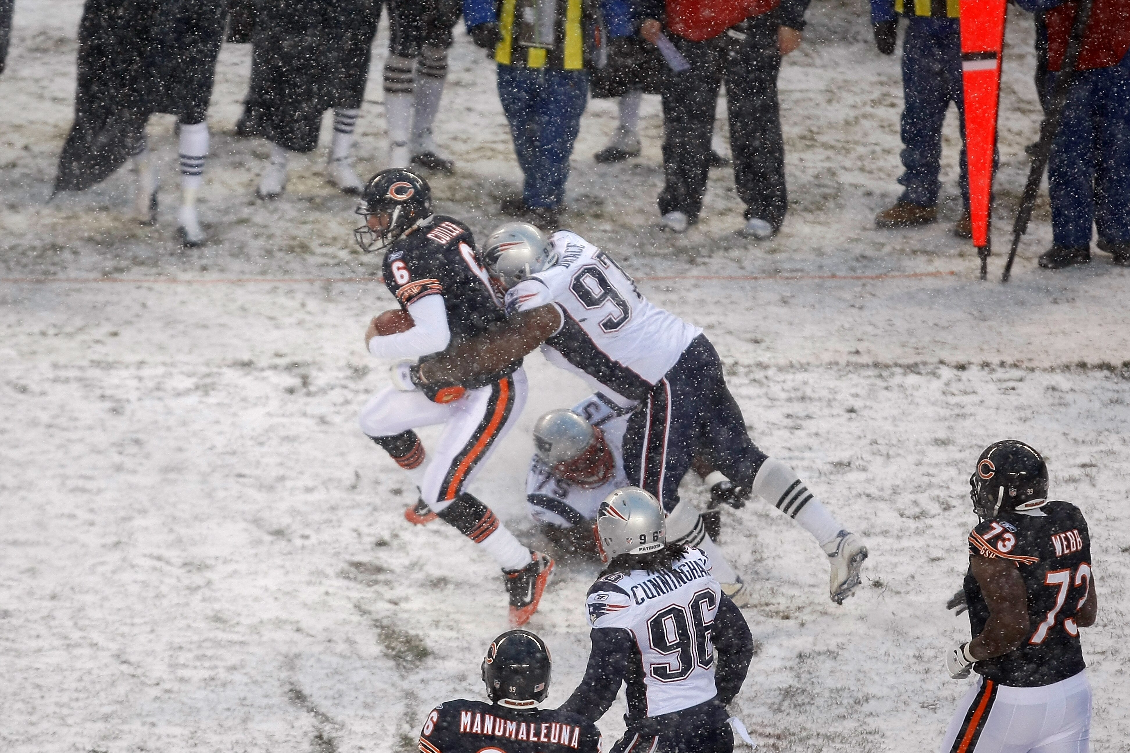 CHICAGO, IL - DECEMBER 12: Jay Cutler #6 of the Chicago Bears runs as he is tackled by Ron Brace #97 of the New England Patriots at Soldier Field on December 12, 2010 in Chicago, Illinois. The Patriots defeated the Bears 36-7. (Photo by Scott Boehm/Getty