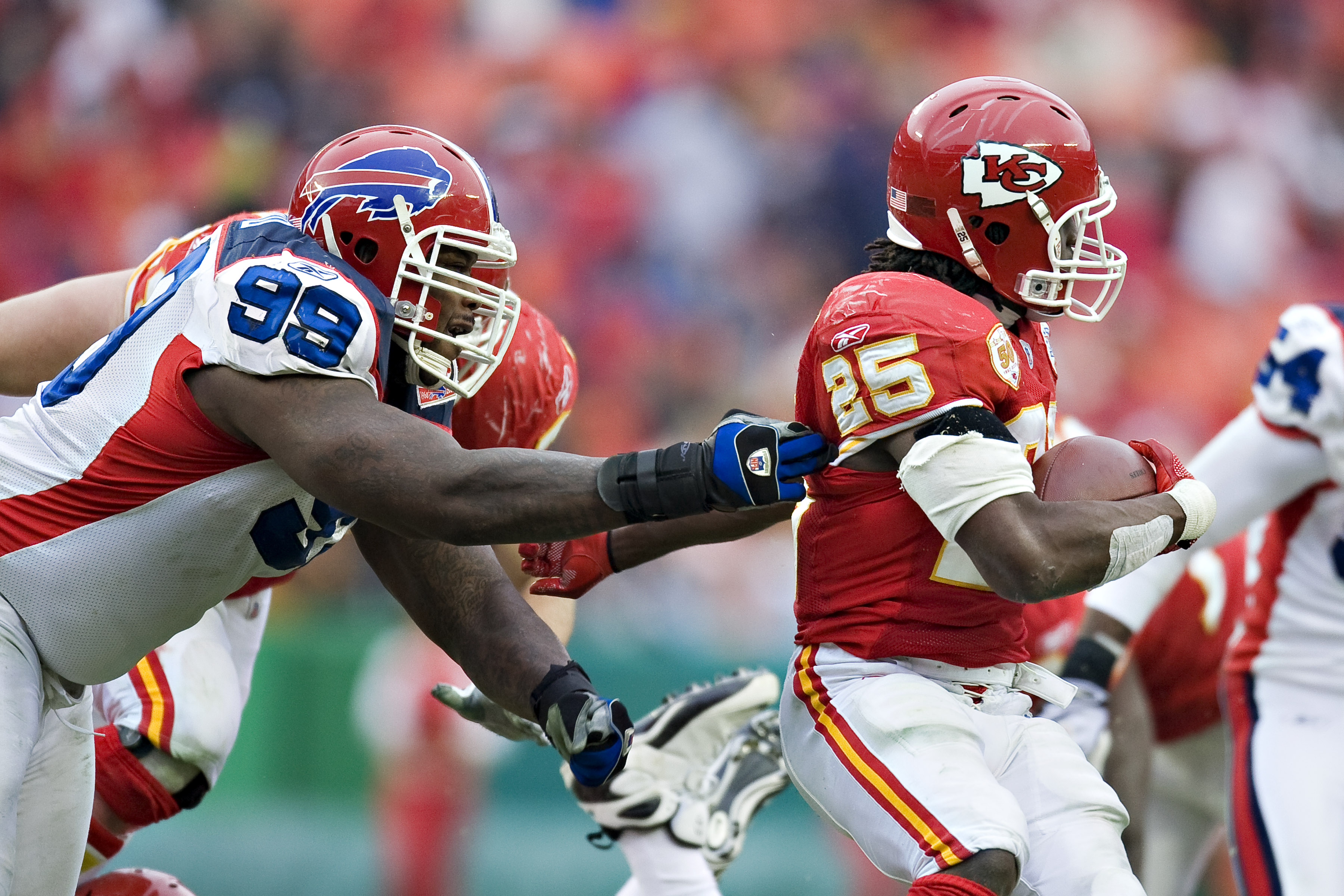 KANSAS CITY, MO - DECEMBER 13: Defensive tackle Marcus Stroud #99 of the Buffalo Bills grabs the jersey of running back Jamaal Charles #25 of the Kansas City Chiefs at Arrowhead Stadium on December 13, 2009 Kansas City, Missouri.  The Bills defeated the C