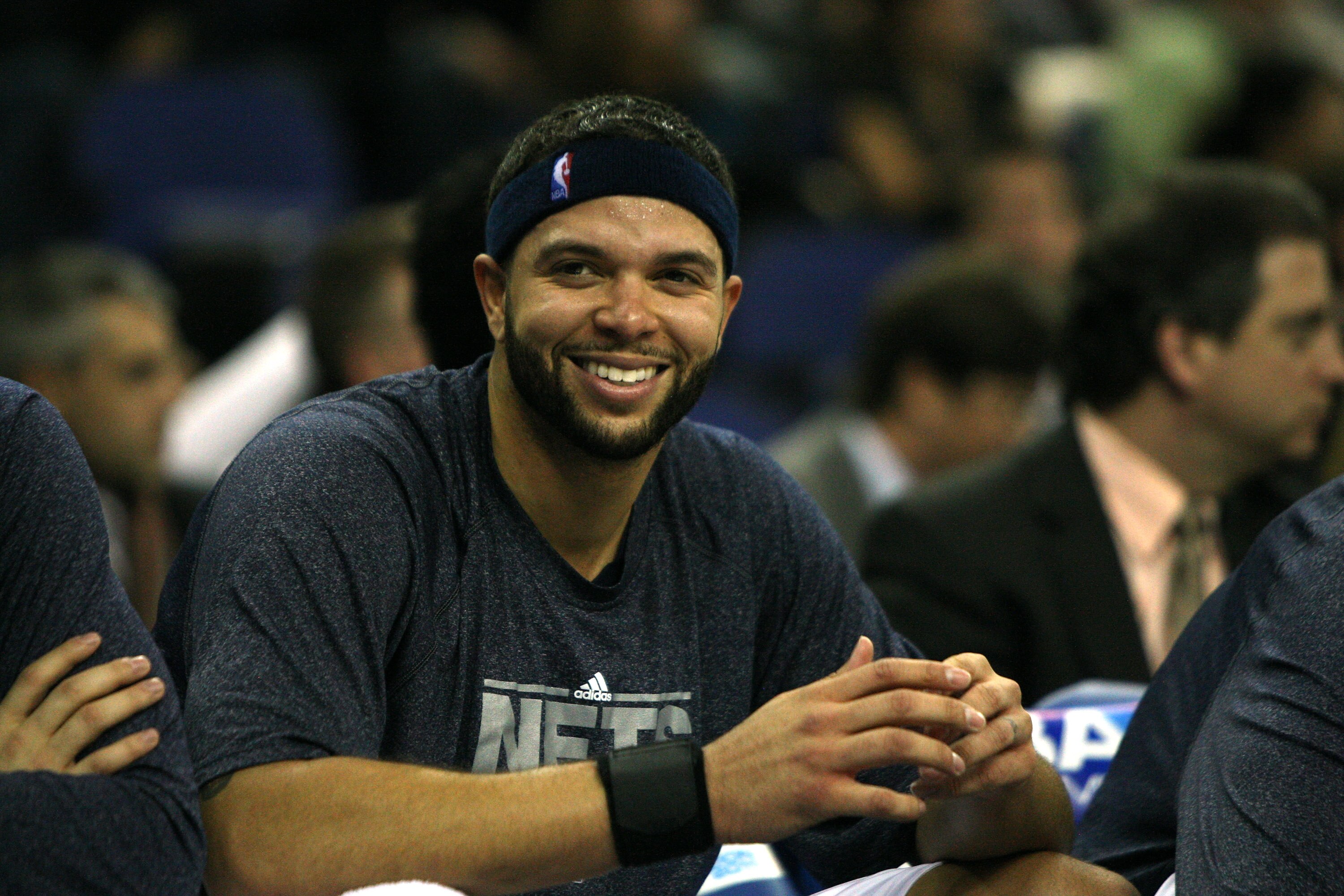 LONDON, ENGLAND - MARCH 04:  #8 Deron Williams of the Netslooks on from the bench during the NBA match between New Jersey Nets and the Toronto Raptors at the O2 Arena on March 4, 2011 in London, England. NOTE TO USER: User expressly acknowledges and agree