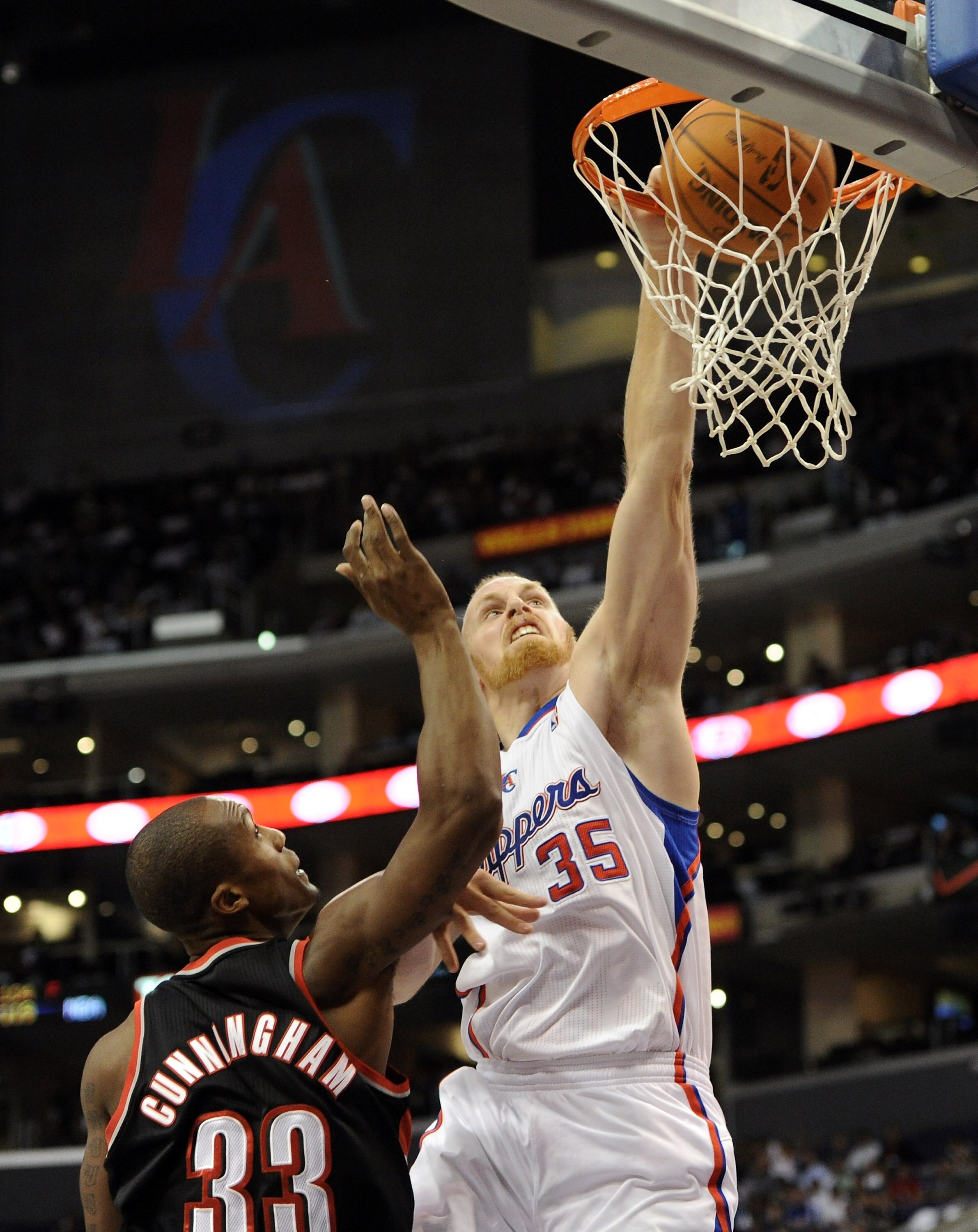 LOS ANGELES, CA - OCTOBER 27:  Chris Kaman #35 of the Los Angeles Clippers dunks over Dante Cunningham #33 of the Portland Trail Blazers during the first half at Staples Center on October 27, 2010 in Los Angeles, California. NOTE TO USER: User expressly a