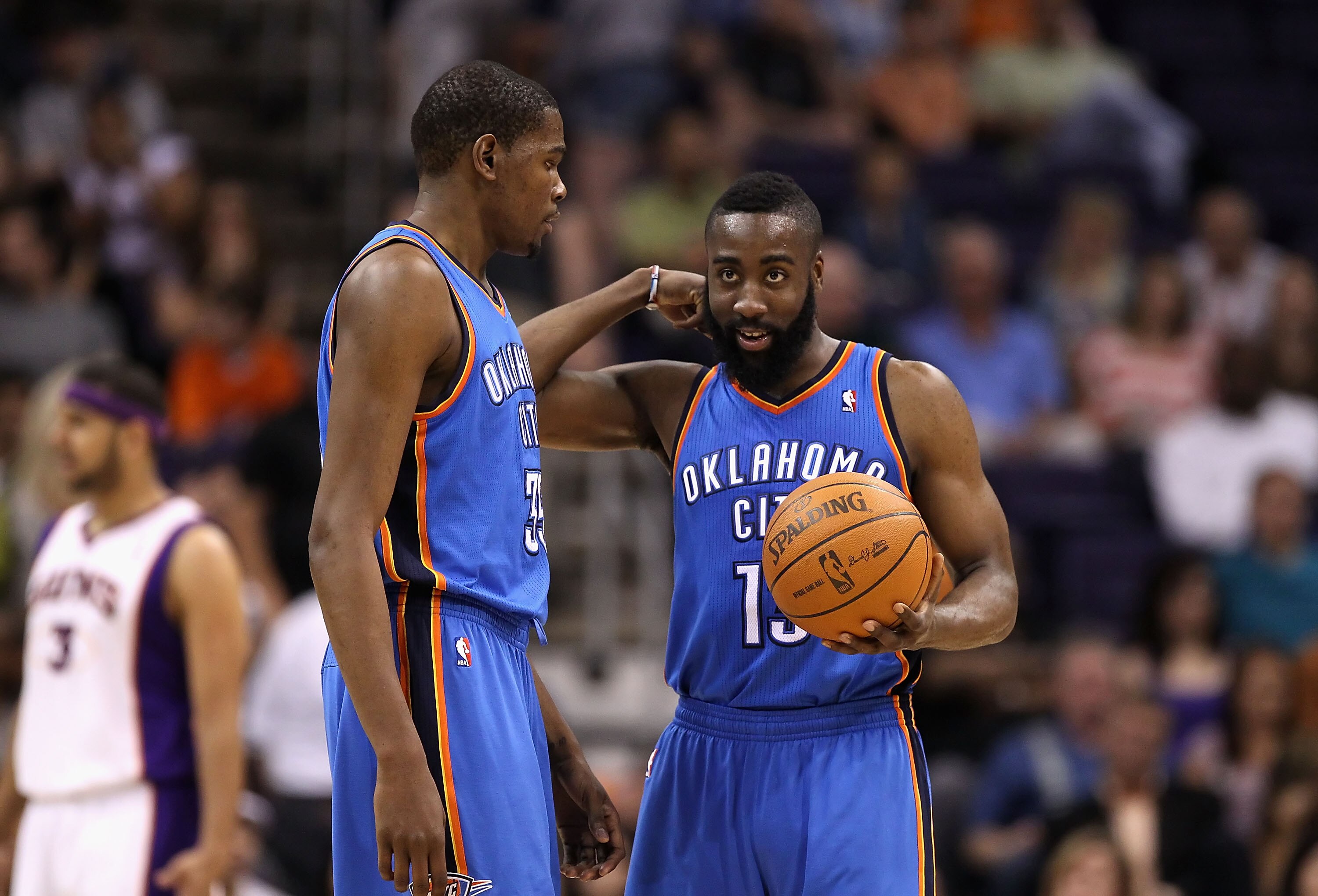 PHOENIX, AZ - MARCH 30:  Kevin Durant #35 and James Harden #13 of the Oklahoma City Thunder talk during the NBA game against the Phoenix Suns at US Airways Center on March 30, 2011 in Phoenix, Arizona. The Thunder defeated the Suns 116-98.   NOTE TO USER: