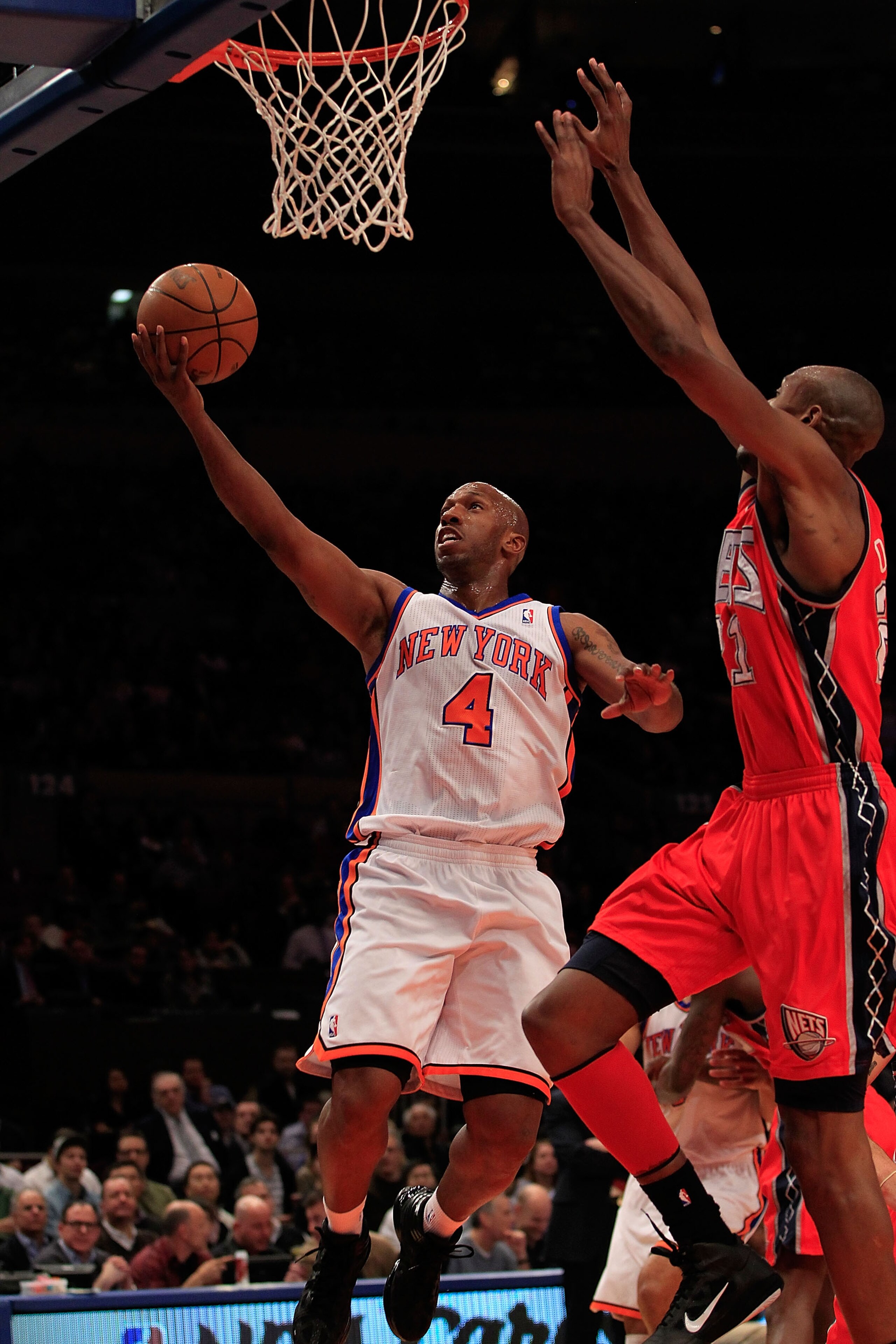 NEW YORK, NY - MARCH 30: Chauncey Billups #4 of the New York Knicks shoots over Travis Outlaw#21 of the New Jersey Nets at Madison Square Garden on March 30, 2011 in New York City. NOTE TO USER: User expressly acknowledges and agrees that, by downloading 