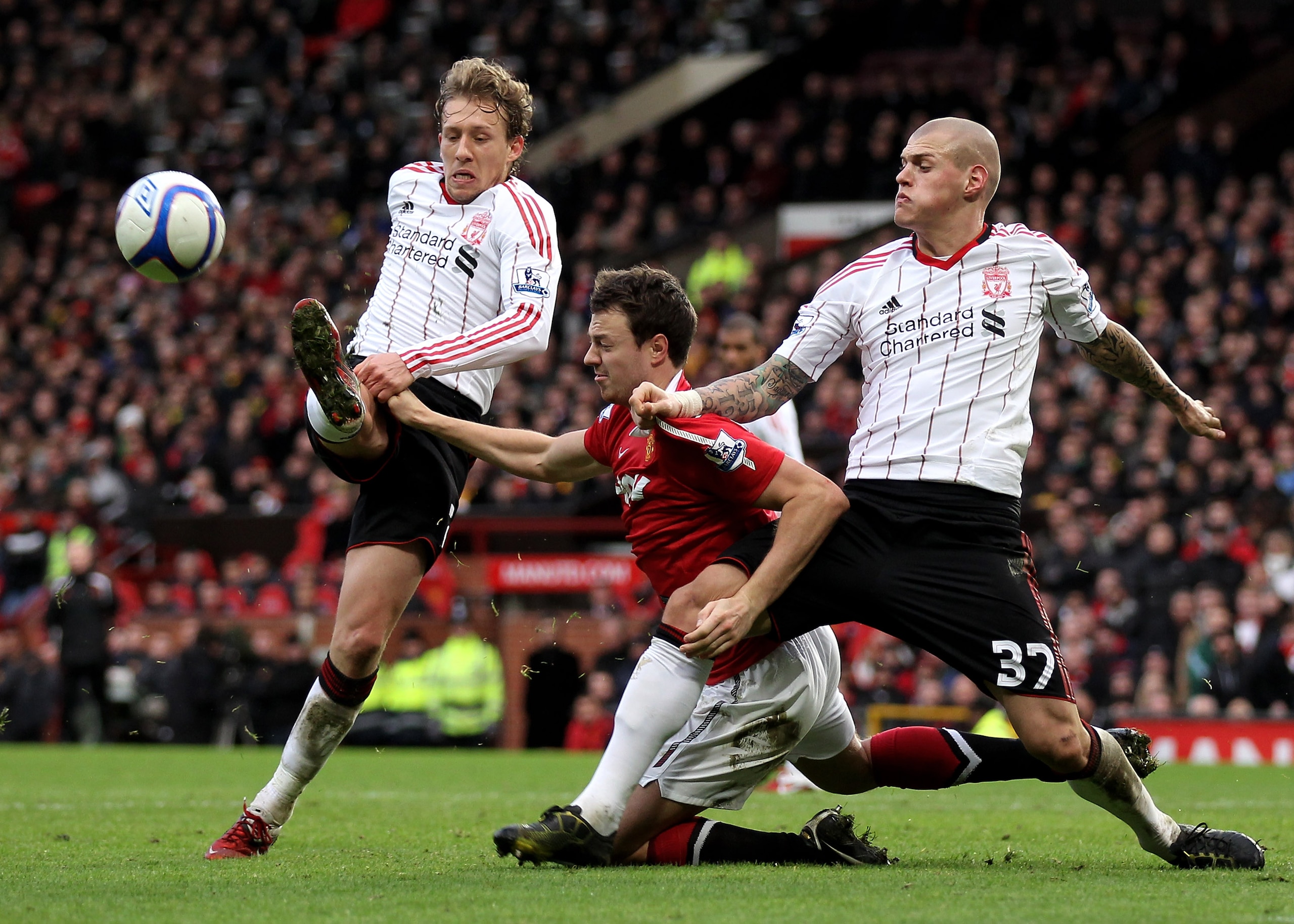 MANCHESTER, ENGLAND - JANUARY 09: Jonny Evans of Manchester United tangles with Martin Skrtel of Liverpool in the penalty area during the FA Cup sponsored by E.ON 3rd round match between Manchester United and Liverpool at Old Trafford on January 9, 2011 MANCHESTER, ENGLAND - JANUARY 09: Jonny Evans of Manchester United tangles with Martin Skrtel of Liverpool in the penalty area during the FA Cup sponsored by E.ON 3rd round match between Manchester United and Liverpool at Old Trafford on January 9, 2011