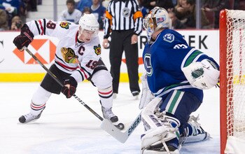 VANCOUVER, CANADA - NOVEMBER 20: Goalie Cory Schneider #35 of the Vancouver Canucks slides across his crease to stop Jonathan Toews #19 of the Chicago Blackhawks during the third period in NHL action on November 20, 2010 at Rogers Arena in Vancouver, Brit
