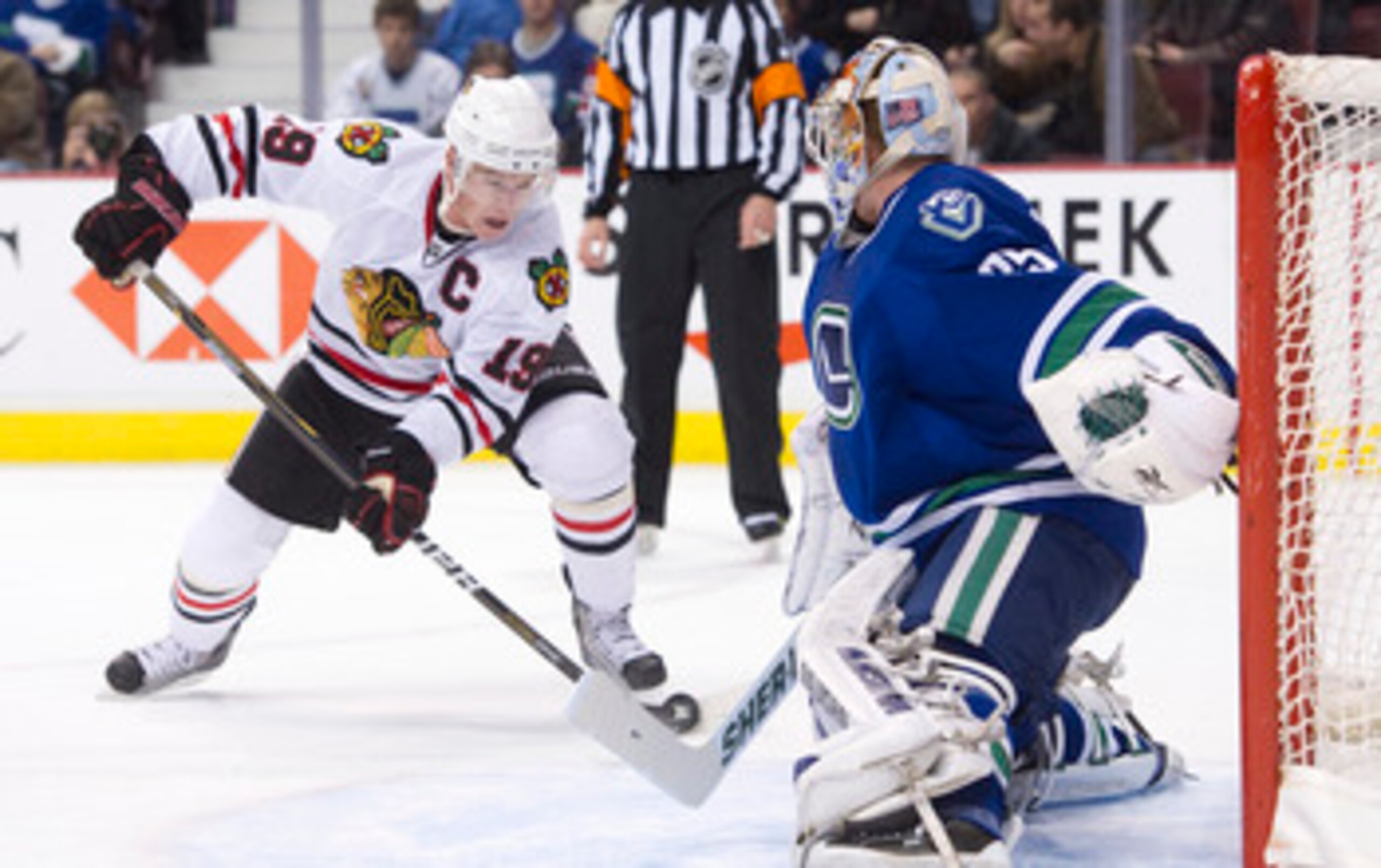 VANCOUVER, CANADA - NOVEMBER 20: Goalie Cory Schneider #35 of the Vancouver Canucks slides across his crease to stop Jonathan Toews #19 of the Chicago Blackhawks during the third period in NHL action on November 20, 2010 at Rogers Arena in Vancouver, Brit
