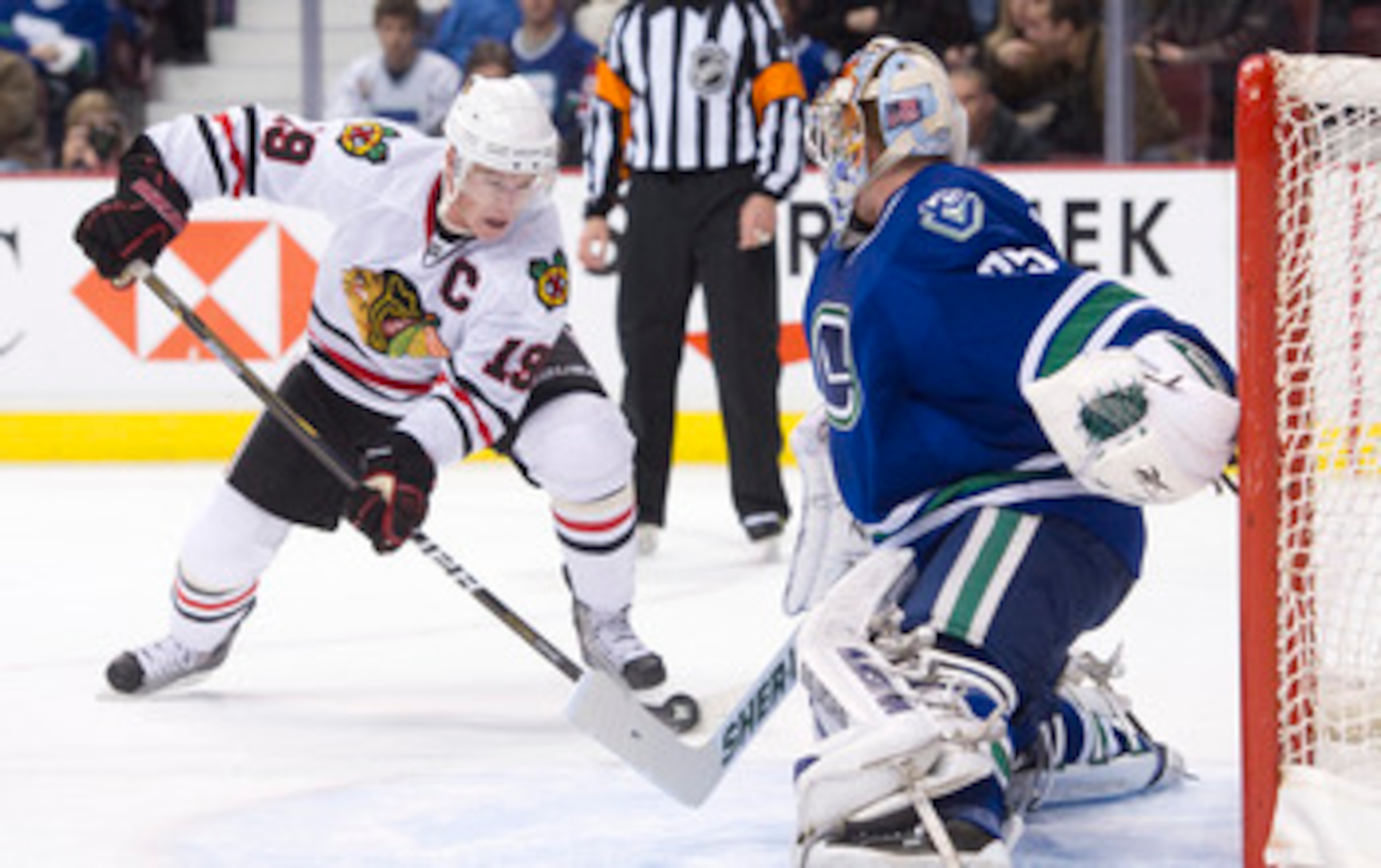 VANCOUVER, CANADA - NOVEMBER 20: Goalie Cory Schneider #35 of the Vancouver Canucks slides across his crease to stop Jonathan Toews #19 of the Chicago Blackhawks during the third period in NHL action on November 20, 2010 at Rogers Arena in Vancouver, Brit