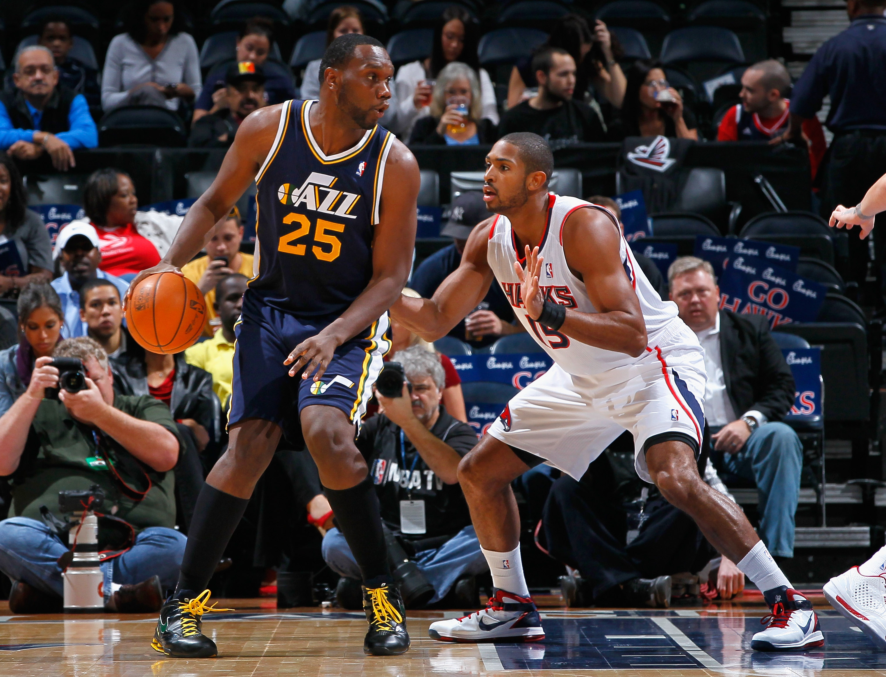 ATLANTA - NOVEMBER 12:  Al Jefferson #25 of the Utah Jazz against Al Horford #15 of the Atlanta Hawks at Philips Arena on November 12, 2010 in Atlanta, Georgia.  NOTE TO USER: User expressly acknowledges and agrees that, by downloading and/or using this P