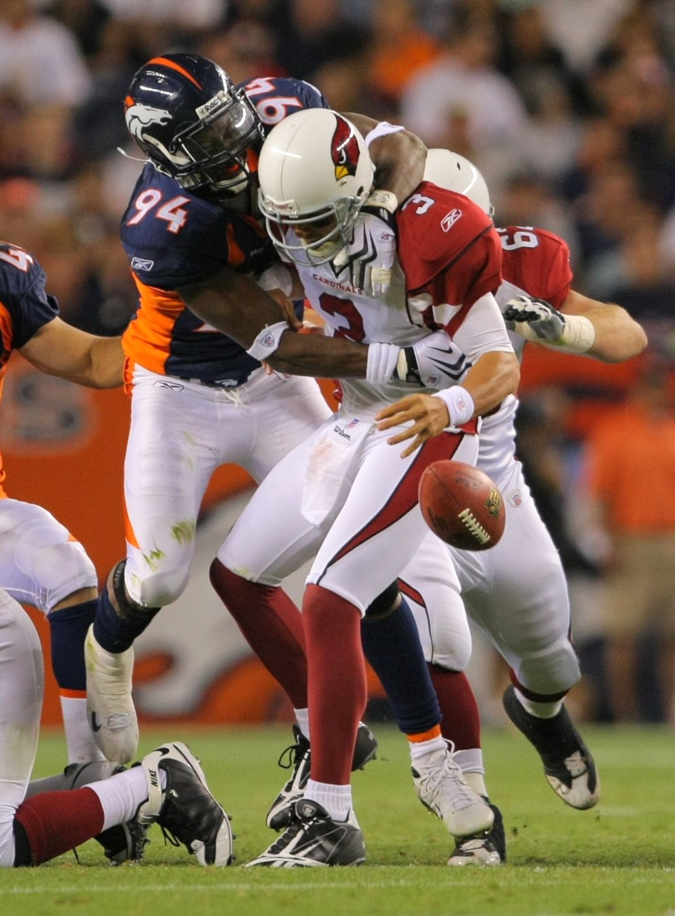 DENVER - SEPTEMBER 3: Quarterback Tyler Palko #3 of the Denver Broncos fumbles the ball on a sack by defensive end Jarvis Moss #94 of the Arizona Cardinals in the closing minute of the second quarter of the NFL preseason game at Invesco Field at Mile High
