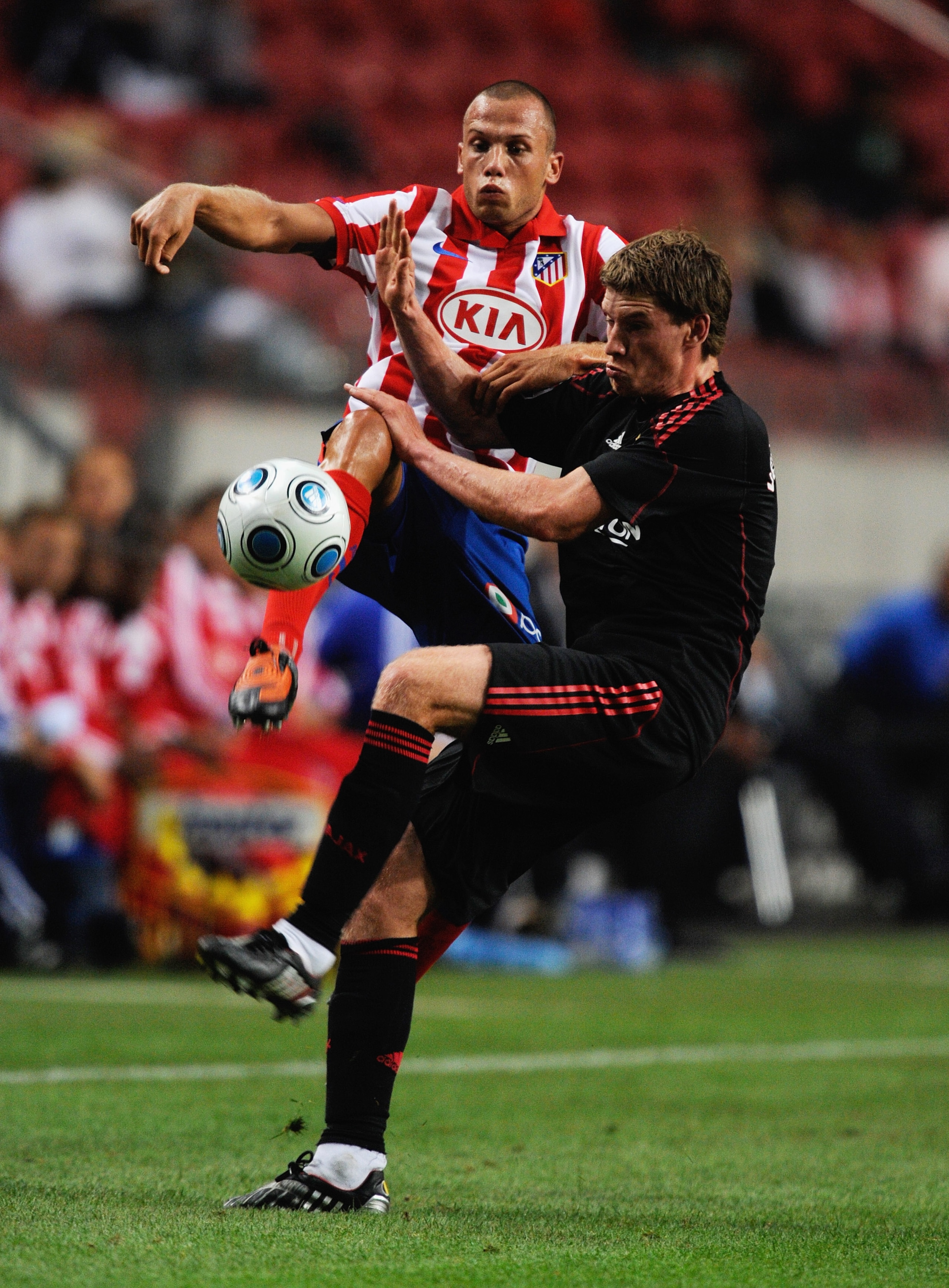 AMSTERDAM, NETHERLANDS - JULY 24:  Atletico Madrid's John Heitinga tackles Jan Vertonghen during the Amsterdam Tournament match between Ajax and Atletico Madrid at the Amsterdam Arena on July 24, 2009 in Amsterdam, Netherlands.  (Photo by Michael Regan/Ge