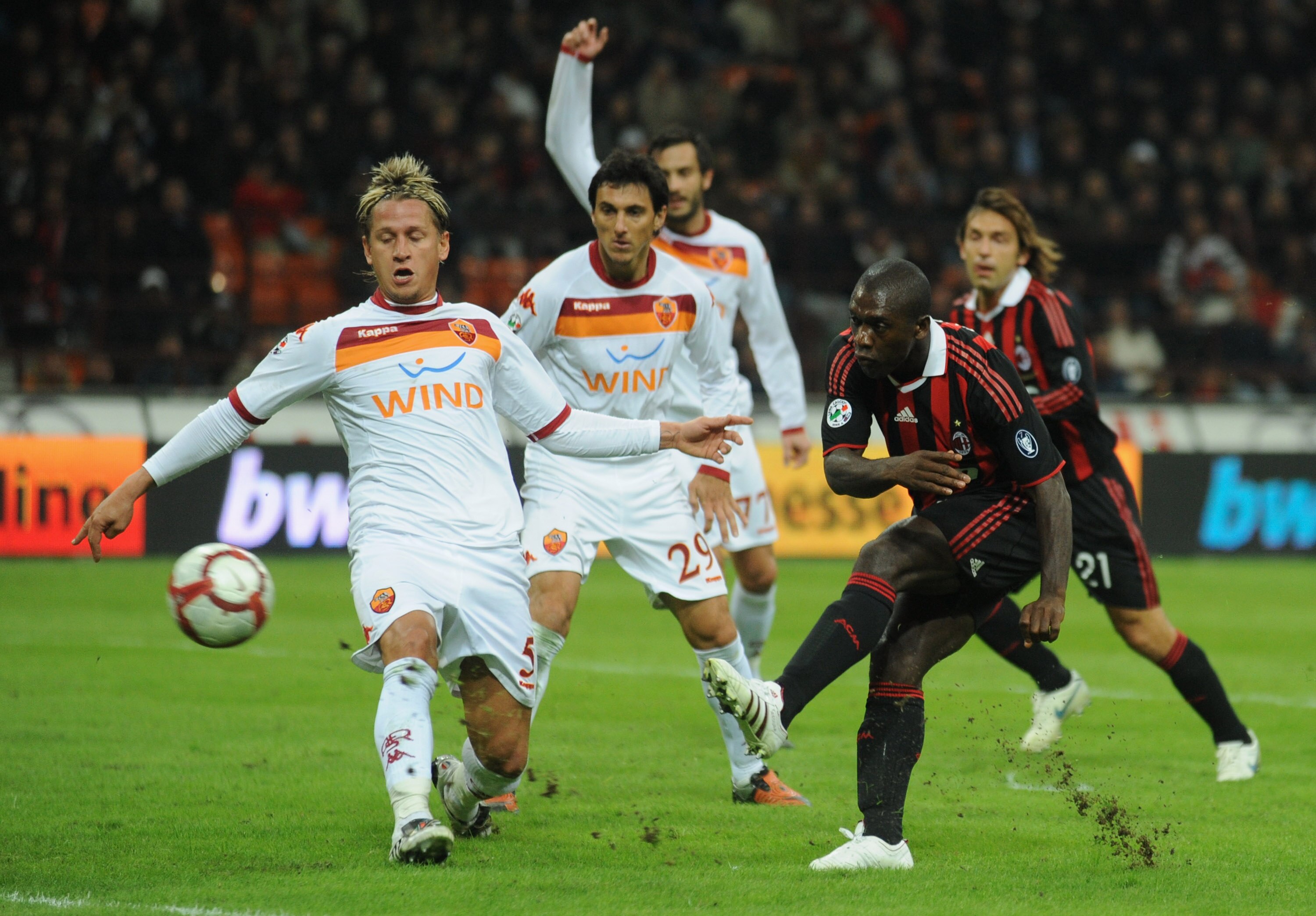 MILAN, ITALY - OCTOBER 18:  Clarence Seedorf (R) of AC Milan is challenged by Philippe Mexès (L) of AS Roma during the Serie A match between AC Milan and AS Roma at Stadio Giuseppe Meazza on October 18, 2009 in Milan, Italy.  (Photo by Valerio Pennicino/G