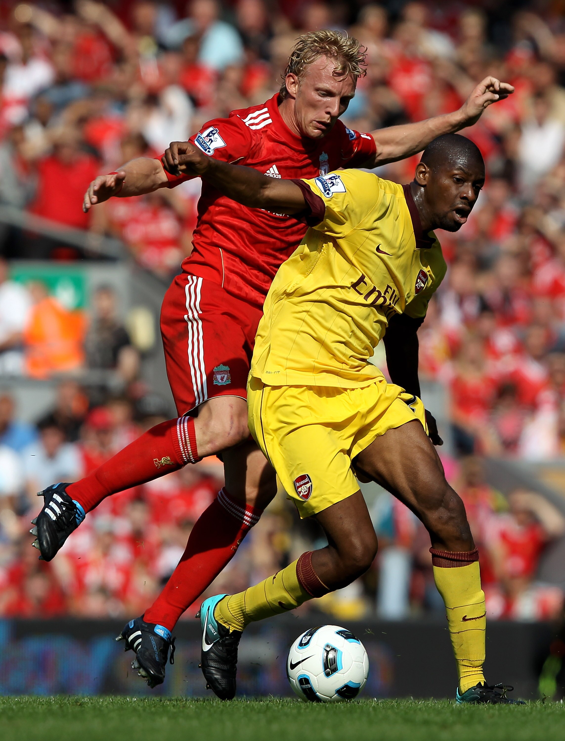 LIVERPOOL, ENGLAND - AUGUST 15:  Abou Diaby of Arsenal battles for the ball with Dirk Kuyt of Liverpool during the Barclays Premier League match between Liverpool and Arsenal at Anfield on August 15, 2010 in Liverpool, England.  (Photo by Clive Brunskill/