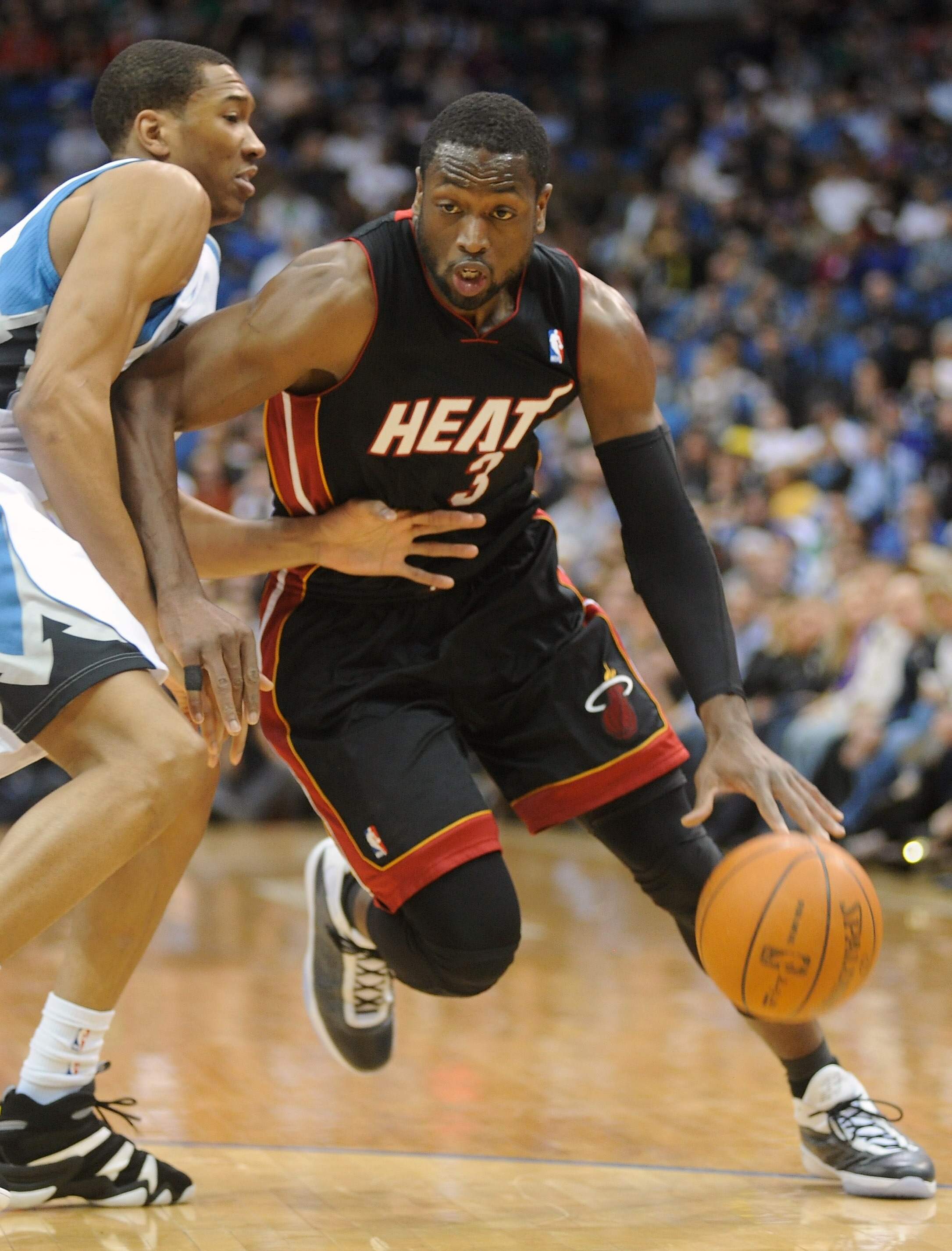 MINNEAPOLIS, MN - APRIL 1: Dwyane Wade #3 of the Miami Heat drives to the basket against Wesley Johnson #4 of the Minnesota Timberwolves during the first half of a basketball game at Target Center on April 1, 2011 in Minneapolis, Minnesota. NOTE TO USER: 