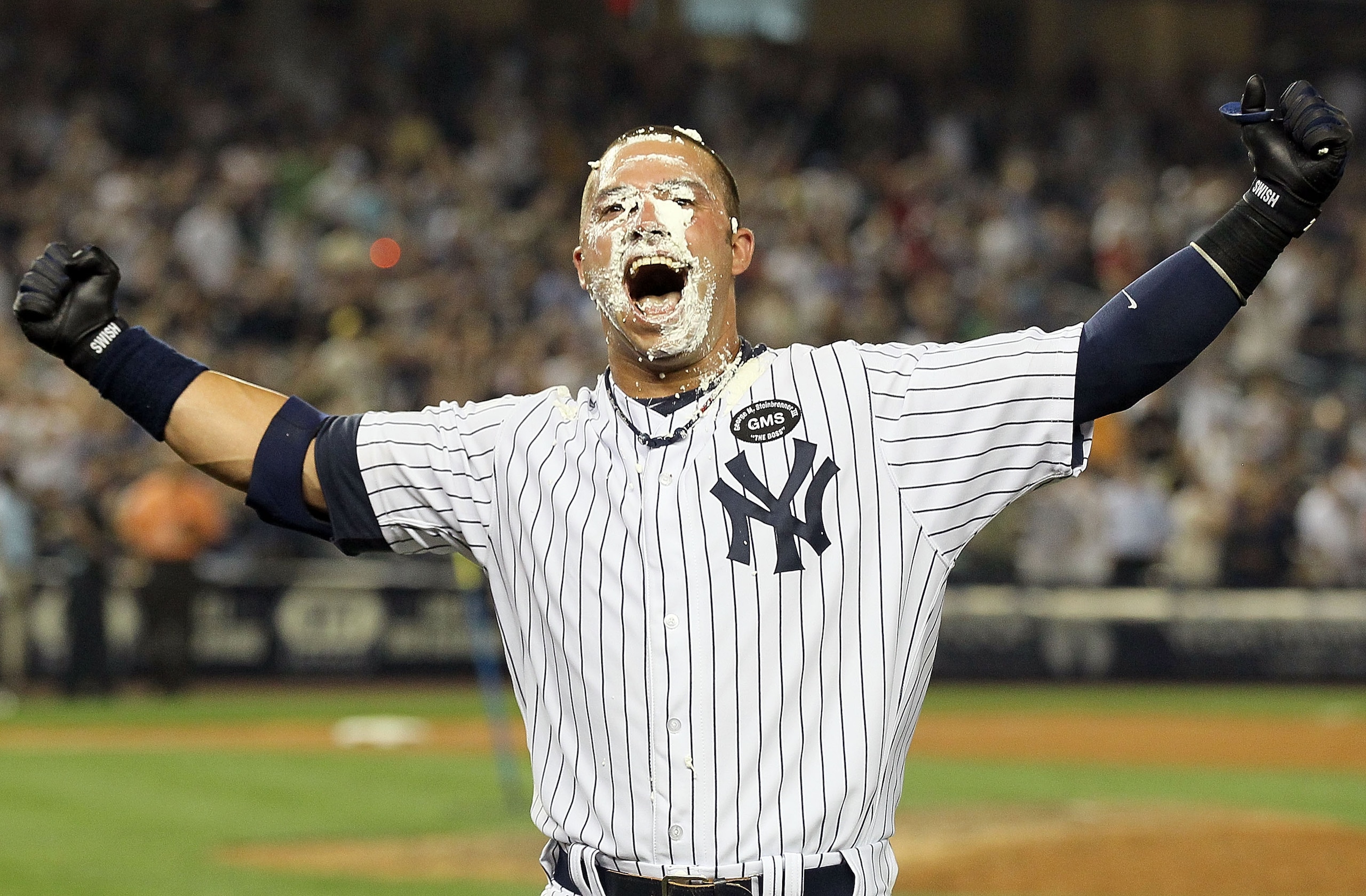 NEW YORK - JULY 16:  Nick Swisher #33 of the New York Yankees celebrates his game winning RBI base hit in the ninth inning against the Tampa Bay Rays on July 16, 2010 at Yankee Stadium in the Bronx borough of New York City. The Yankees defeated the Rays 5