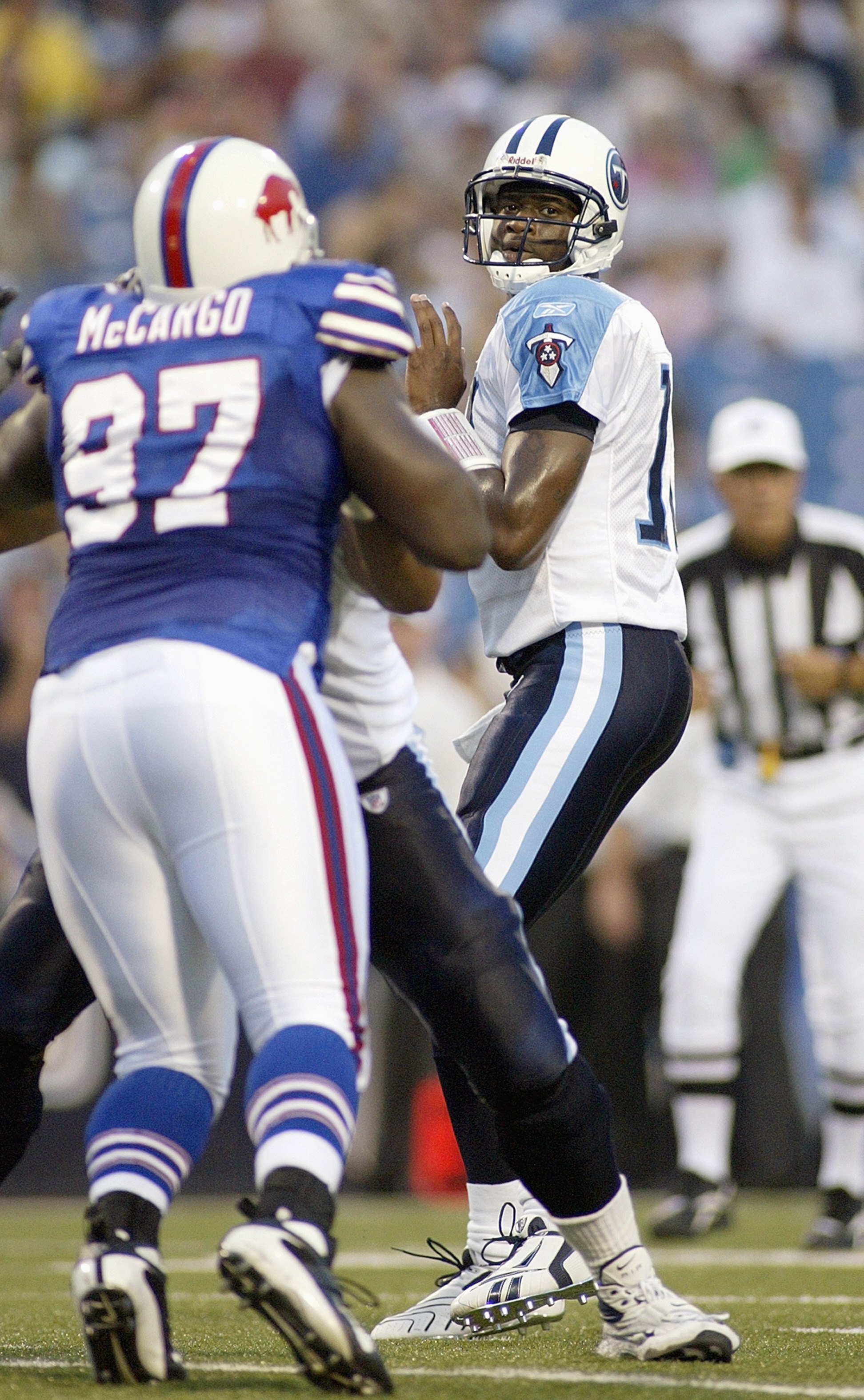 ORCHARD PARK - AUGUST 24: Vince Young #10of the Tennessee Titans looks to pass the ball against John McCargo #97 of the Buffalo Bills at Ralph Wilson Stadium on August 24, 2007 in Orchard Park, New York. (Photo by Rick Stewart/Getty Images)
