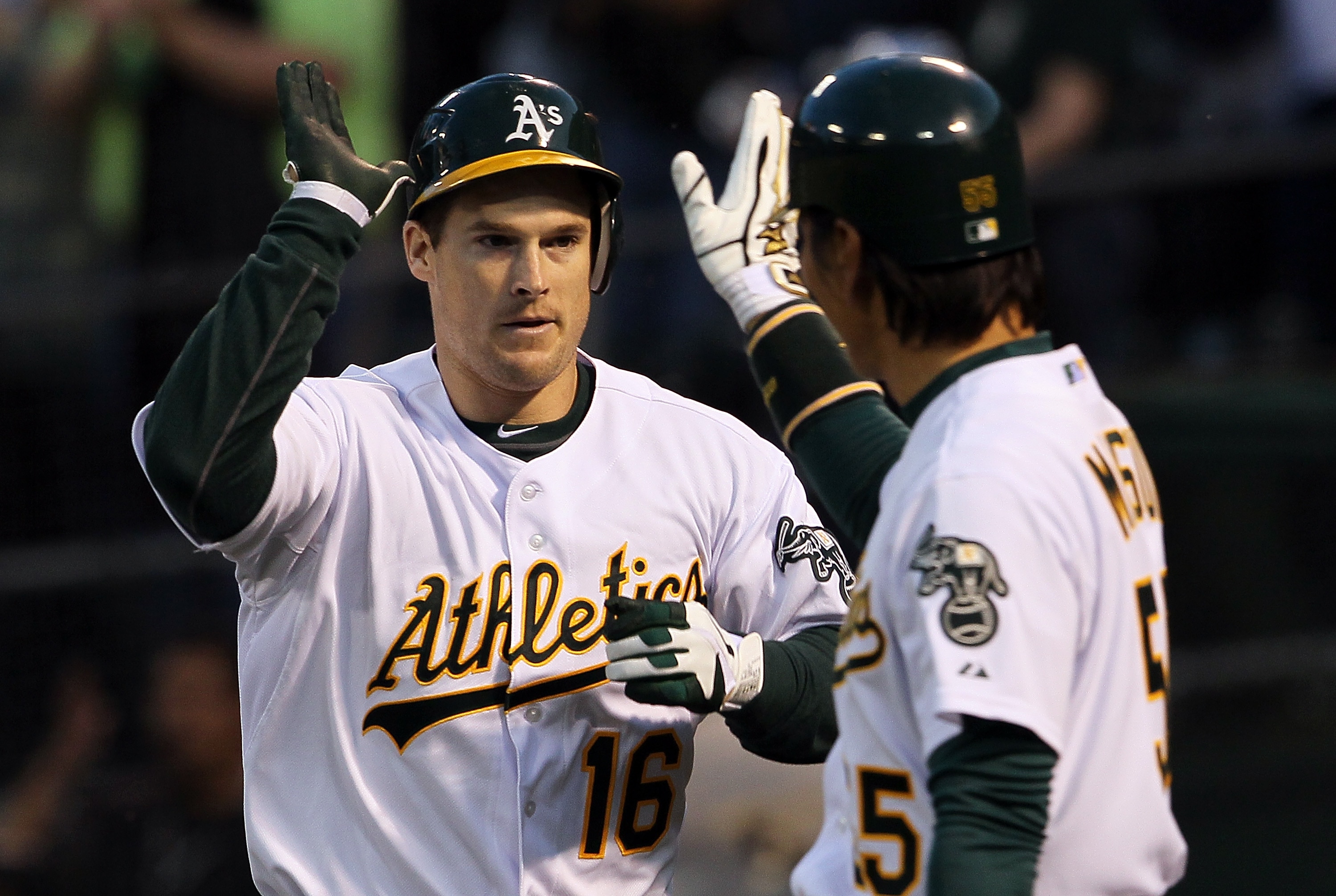 OAKLAND, CA - APRIL 01:  Josh Willingham #16 of the Oakland Athletics is congratulated by Hideki Matsui #55 after hitting a two-run home run during the first inning against the Seattle Mariners at the Oakland-Alameda County Coliseum on April 1, 2011 in Oa