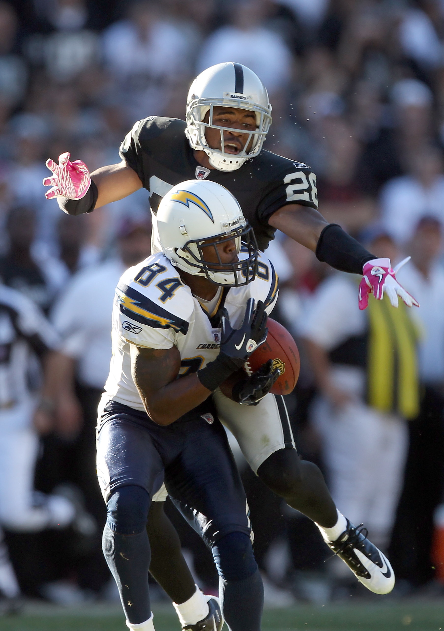 OAKLAND, CA - OCTOBER 10:  Stanford Routt #26 of the Oakland Raiders breaks up a pass intended for Buster Davis #84 of the San Diego Chargers late in the fourth quarter at Oakland-Alameda County Coliseum on October 10, 2010 in Oakland, California.  (Photo