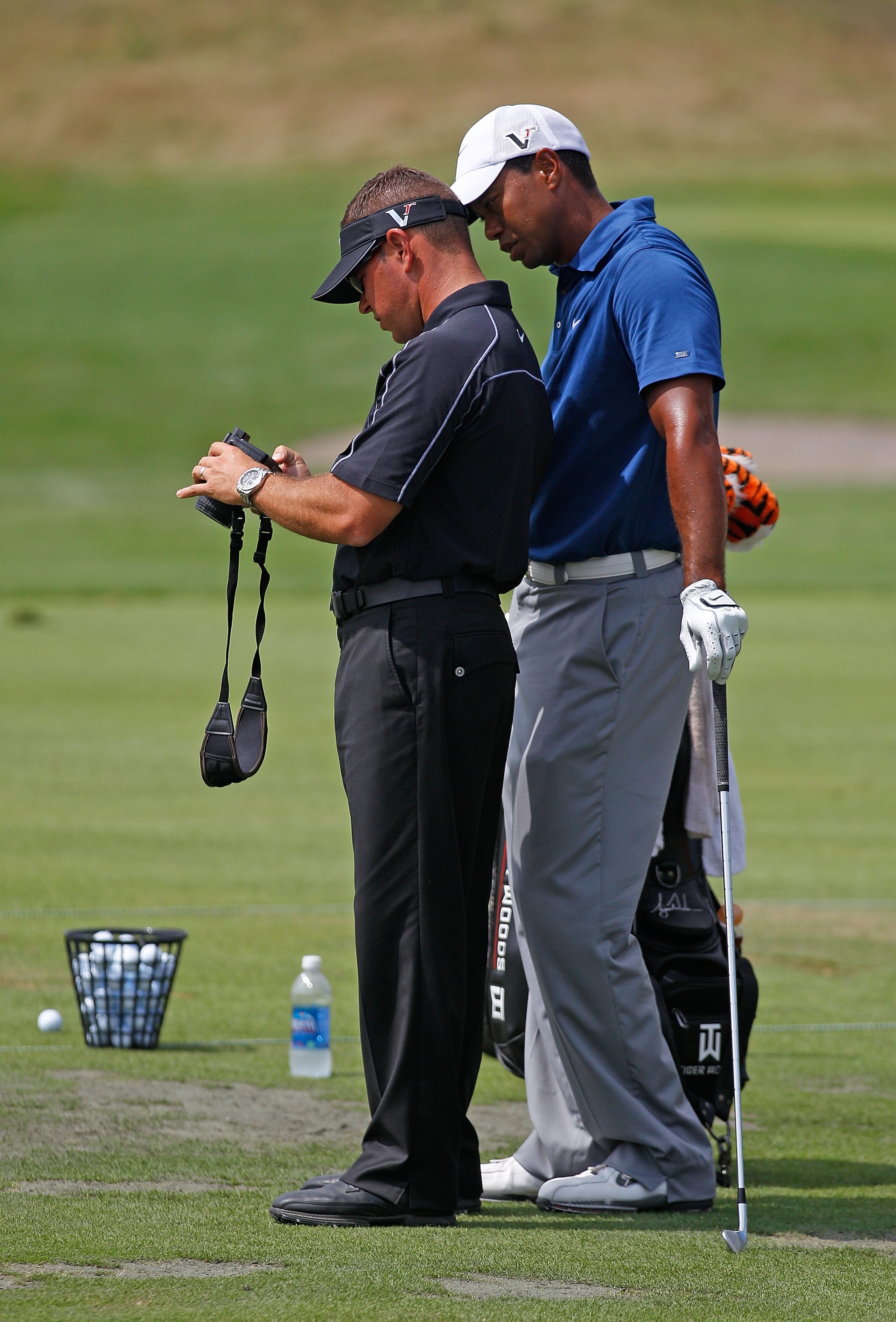 KOHLER, WI - AUGUST 14:  Tiger Woods works with golf instructor Sean Foley on the practice ground prior to the start of the third round of the 92nd PGA Championship on the Straits Course at Whistling Straits on August 14, 2010 in Kohler, Wisconsin.  (Phot