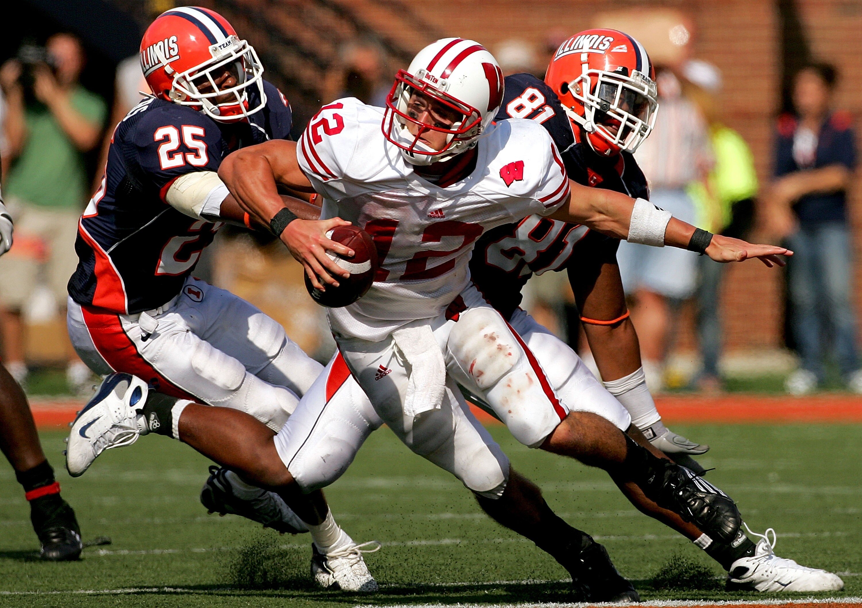 CHAMPAIGN, IL - OCTOBER 06: Justin Harrison #25 and Will Davis #81 of the Illinois Fighting Illini chase Quarterback Tyler Donovan #12 of the Wisconsin Badgers October 6, 2007 at Memorial Stadium in Champaign, Illinois.  (Photo by Matthew Stockman/Getty I