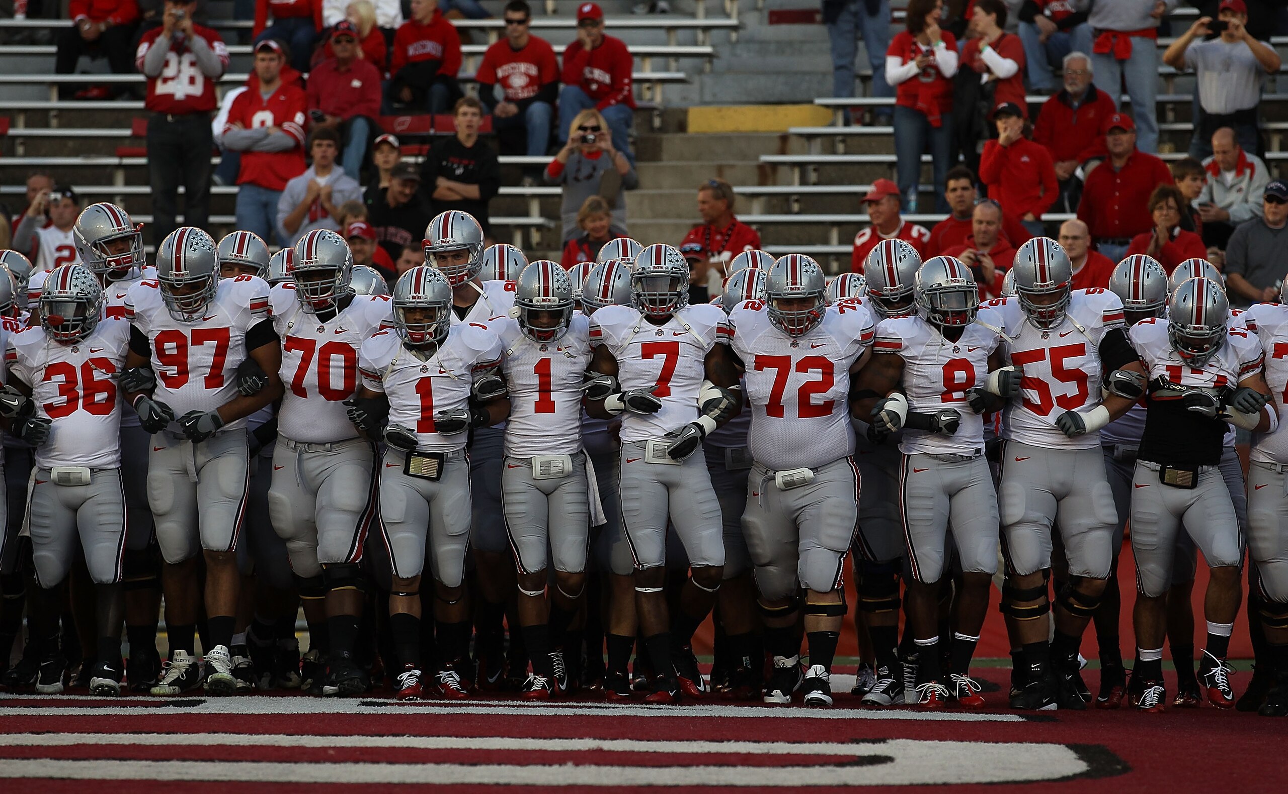 MADISON, WI - OCTOBER 16: Members of the Ohio State Buckeyes including Devon Torrence #1, Jermale Hines #7, Dexter Larimore #72 and Aaron Gant #8 walk on to the field for warm-ups before a game against the Wisconsin Badgers at Camp Randall Stadium on Octo MADISON, WI - OCTOBER 16: Members of the Ohio State Buckeyes including Devon Torrence #1, Jermale Hines #7, Dexter Larimore #72 and Aaron Gant #8 walk on to the field for warm-ups before a game against the Wisconsin Badgers at Camp Randall Stadium on Octo