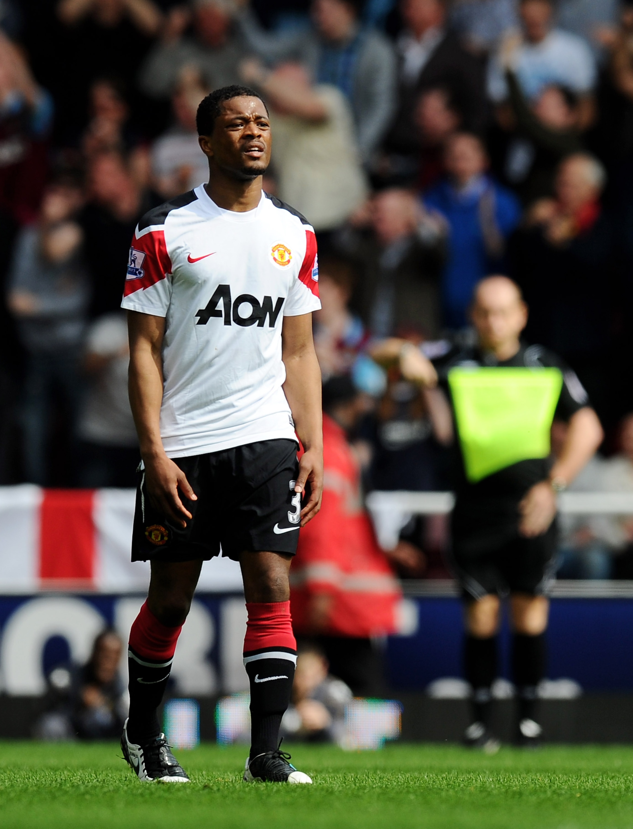 LONDON, ENGLAND - APRIL 02:  Patrice Evra of Manchester United looks dejected after referee Lee Mason awarded the opening penalty during the Barclays Premier League match between West Ham United and Manchester United at the Boleyn Ground on April 2, 2011