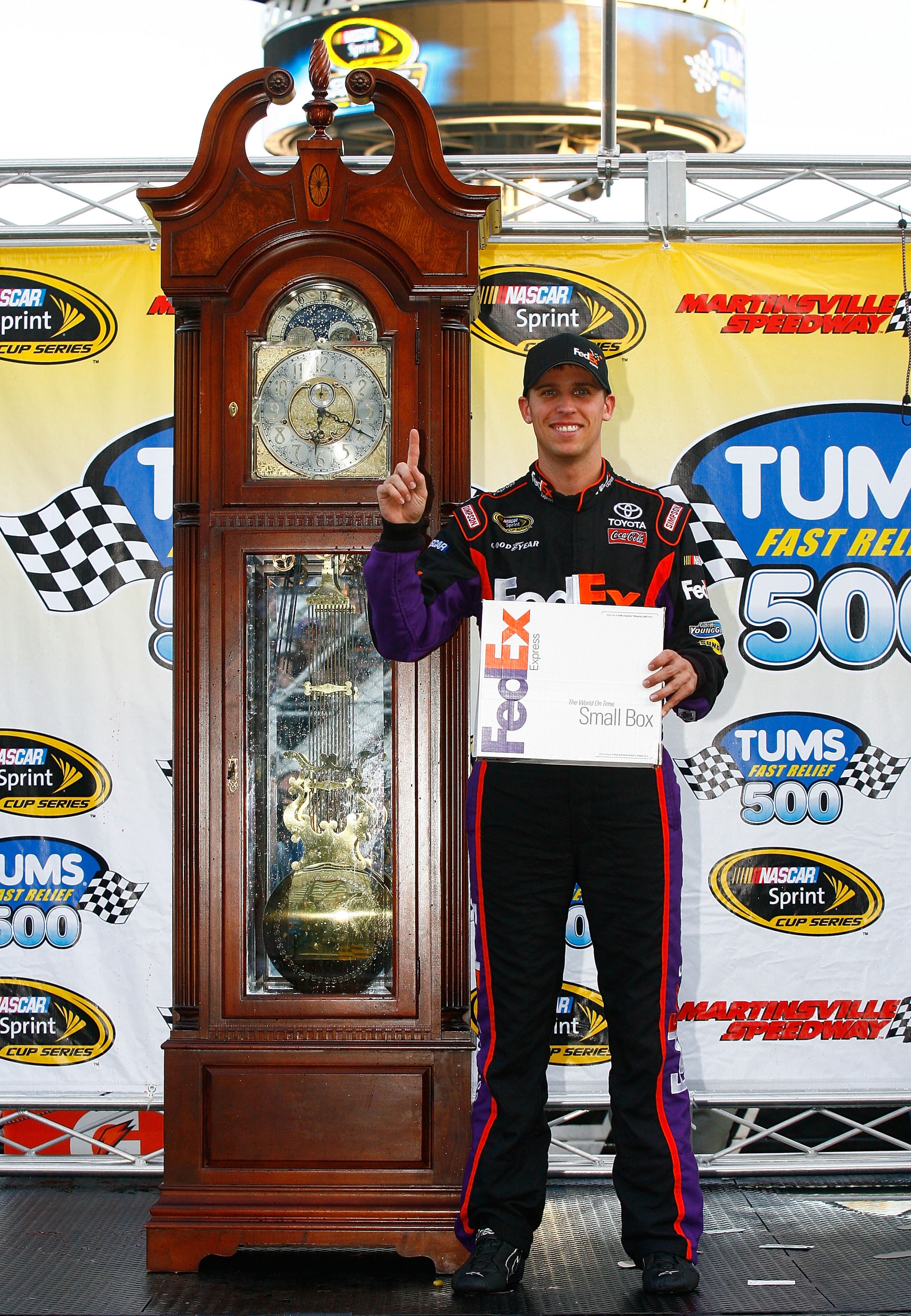 MARTINSVILLE, VA - OCTOBER 24: Denny Hamlin, driver of the #11 FedEx Express Toyota, poses in Victory Lane after winning the NASCAR Sprint Cup Series TUMS Fast Relief 500 at Martinsville Speedway on October 24, 2010 in Martinsville, Virginia. (Photo by MARTINSVILLE, VA - OCTOBER 24: Denny Hamlin, driver of the #11 FedEx Express Toyota, poses in Victory Lane after winning the NASCAR Sprint Cup Series TUMS Fast Relief 500 at Martinsville Speedway on October 24, 2010 in Martinsville, Virginia. (Photo by