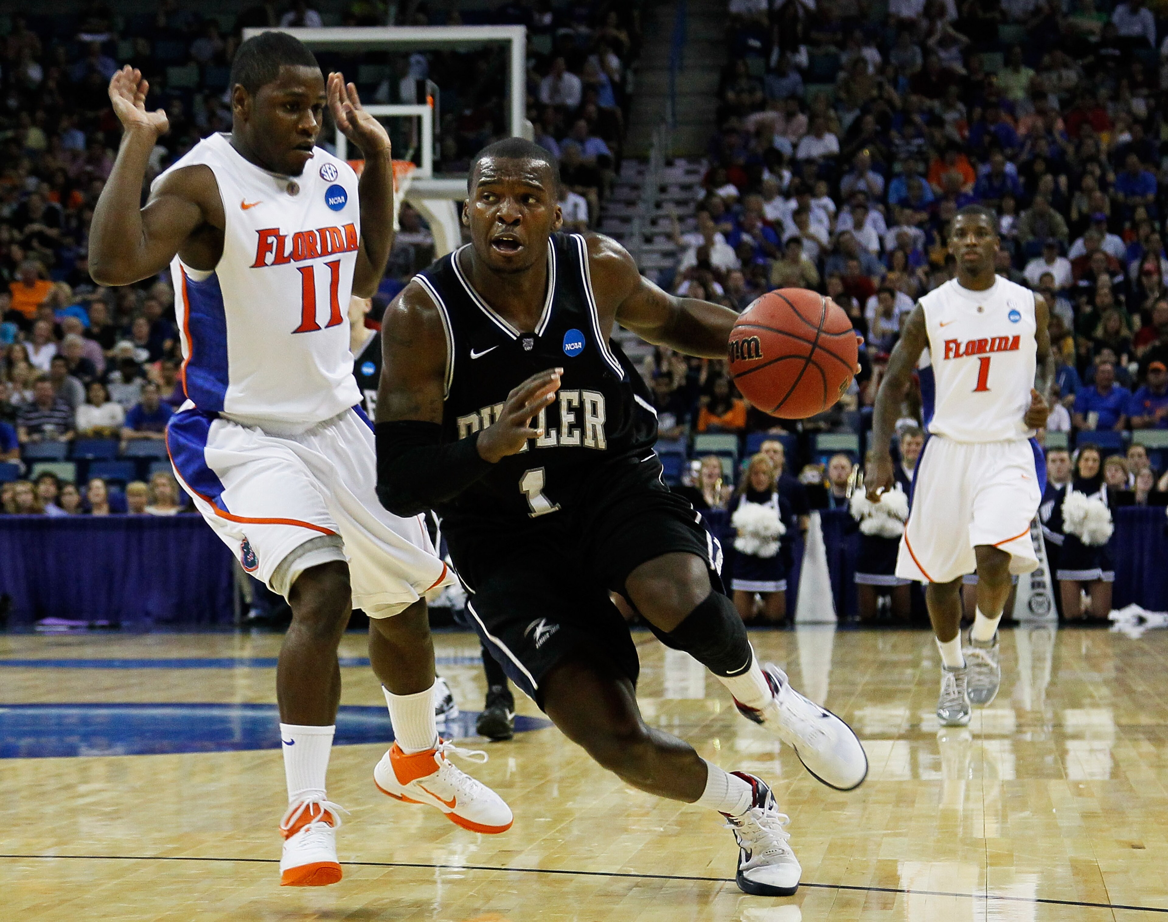 NEW ORLEANS, LA - MARCH 26:  Shelvin Mack #1 of the Butler Bulldogs drives past Erving Walker #11 of the Florida Gators during the Southeast regional final of the 2011 NCAA men's basketball tournament at New Orleans Arena on March 26, 2011 in New Orleans,