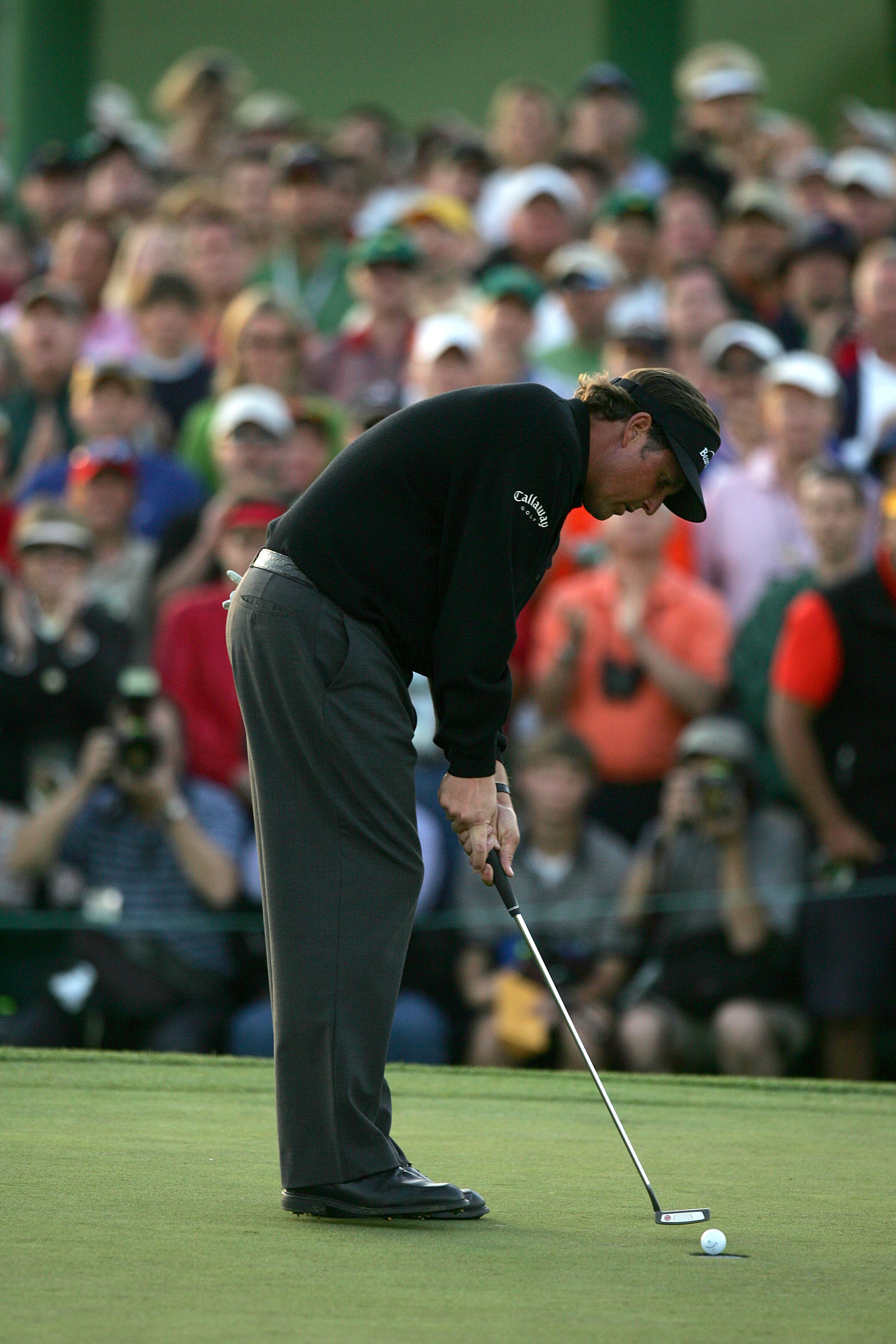 AUGUSTA, GA - APRIL 09:  Phil Mickelson sinks his final putt on the 18th hole en route to his 7-under par victory during the Final Round of The Masters at the Augusta National Golf Club on April 9, 2006 in Augusta, Georgia. (Photo by Getty Images)