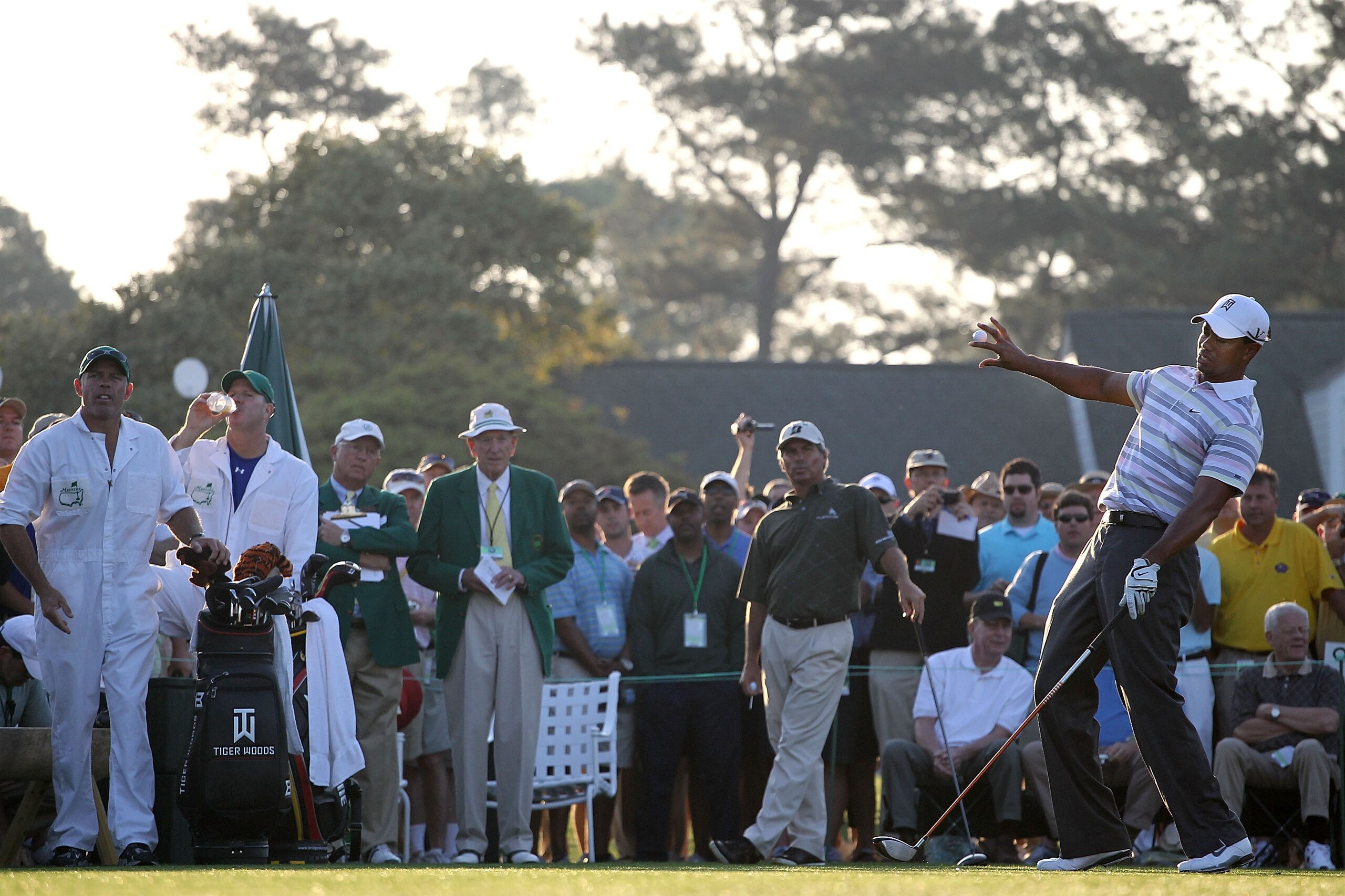 AUGUSTA, GA - APRIL 05:  Tiger Woods reacts to his tee shot on the first hole as Fred Couples and their caddies look on during a practice round prior to the 2010 Masters Tournament at Augusta National Golf Club on April 5, 2010 in Augusta, Georgia.  (Phot