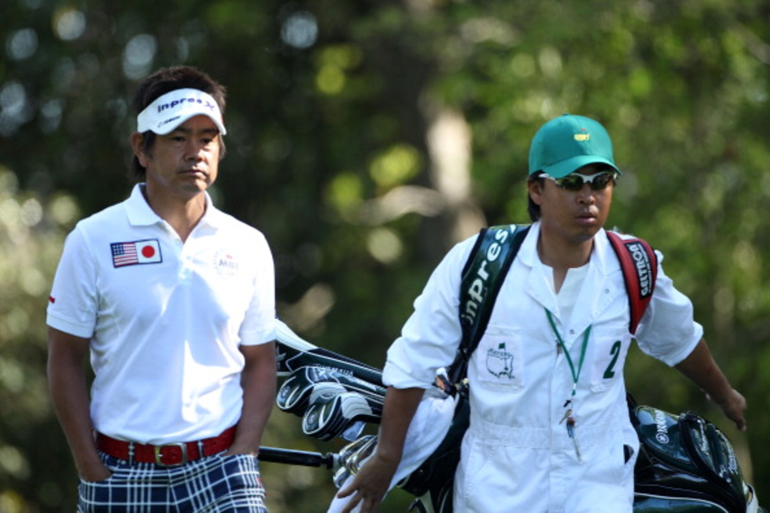 AUGUSTA, GA - APRIL 07: Hiroyuki Fujita of Japan walks with his caddie Atsushi Umehara off the second tee during the first round of the 2011 Masters Tournament at Augusta National Golf Club on April 7, 2011 in Augusta, Georgia. (Photo by Andrew Redingto AUGUSTA, GA - APRIL 07: Hiroyuki Fujita of Japan walks with his caddie Atsushi Umehara off the second tee during the first round of the 2011 Masters Tournament at Augusta National Golf Club on April 7, 2011 in Augusta, Georgia. (Photo by Andrew Redingto