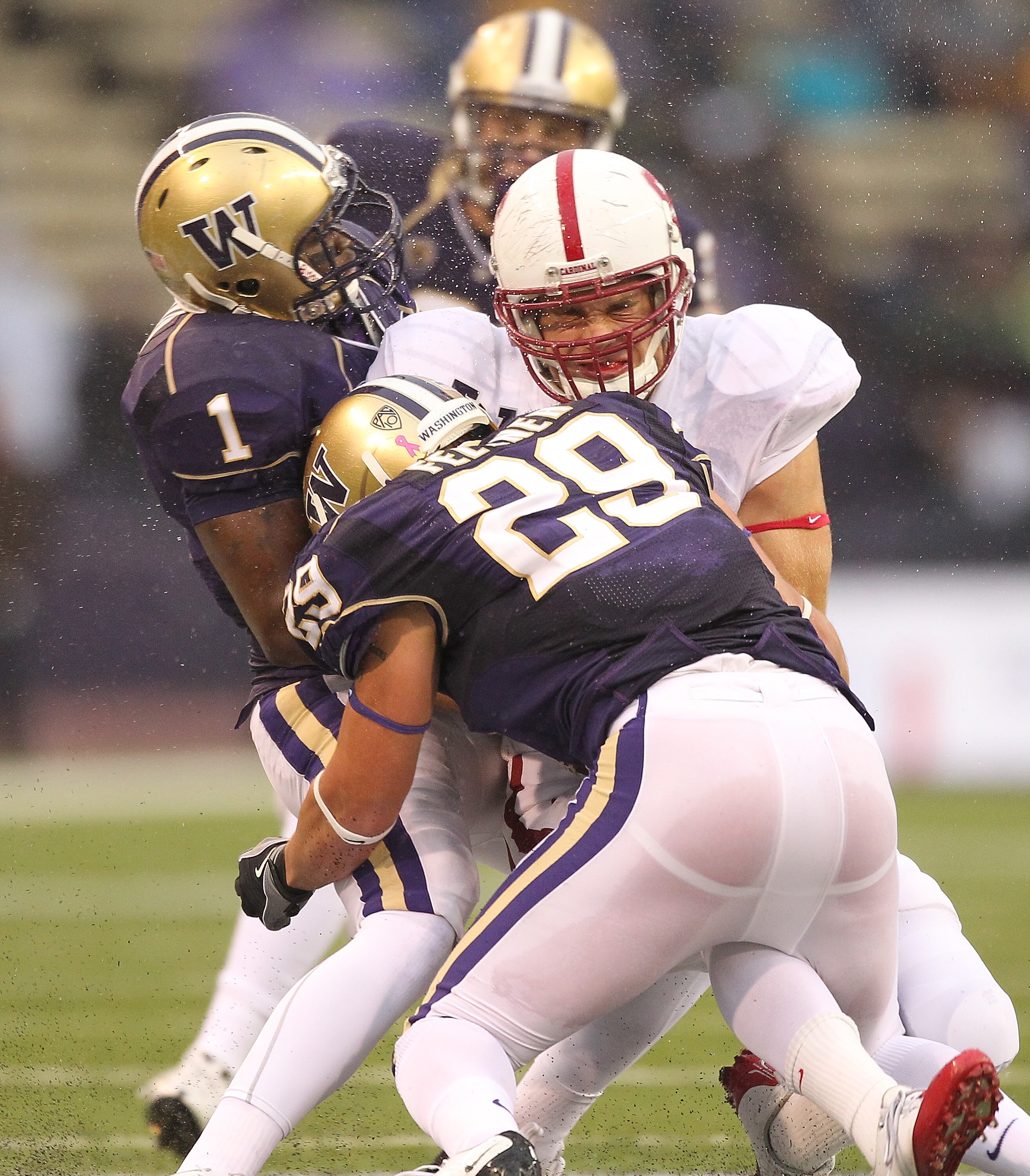 SEATTLE - OCTOBER 30:  Tight end Zach Ertz #86 of the Stanford Cardinal is tackled by Nate Fellner #29 and Sean Parker #1 of the Washington Huskies on October 30, 2010 at Husky Stadium in Seattle, Washington. Stanford defeated Washington 41-0. (Photo by O