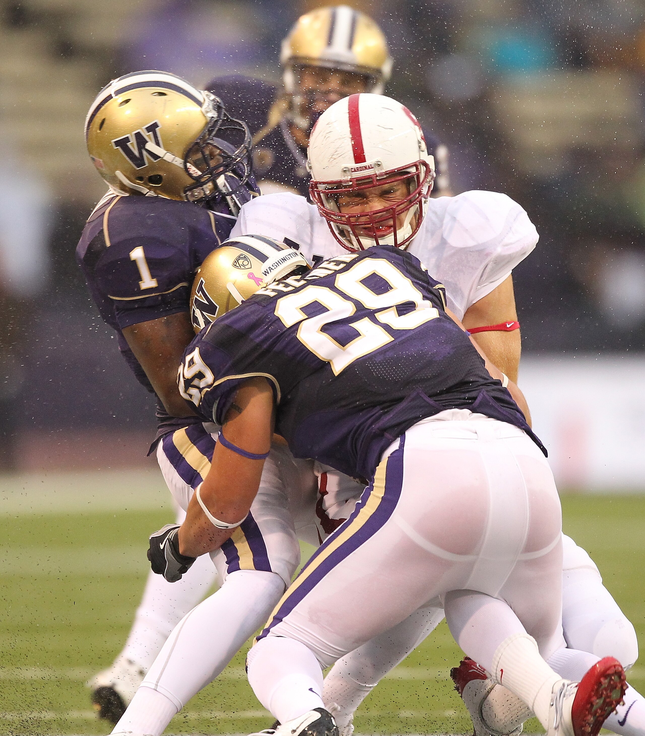 SEATTLE - OCTOBER 30:  Tight end Zach Ertz #86 of the Stanford Cardinal is tackled by Nate Fellner #29 and Sean Parker #1 of the Washington Huskies on October 30, 2010 at Husky Stadium in Seattle, Washington. Stanford defeated Washington 41-0. (Photo by O