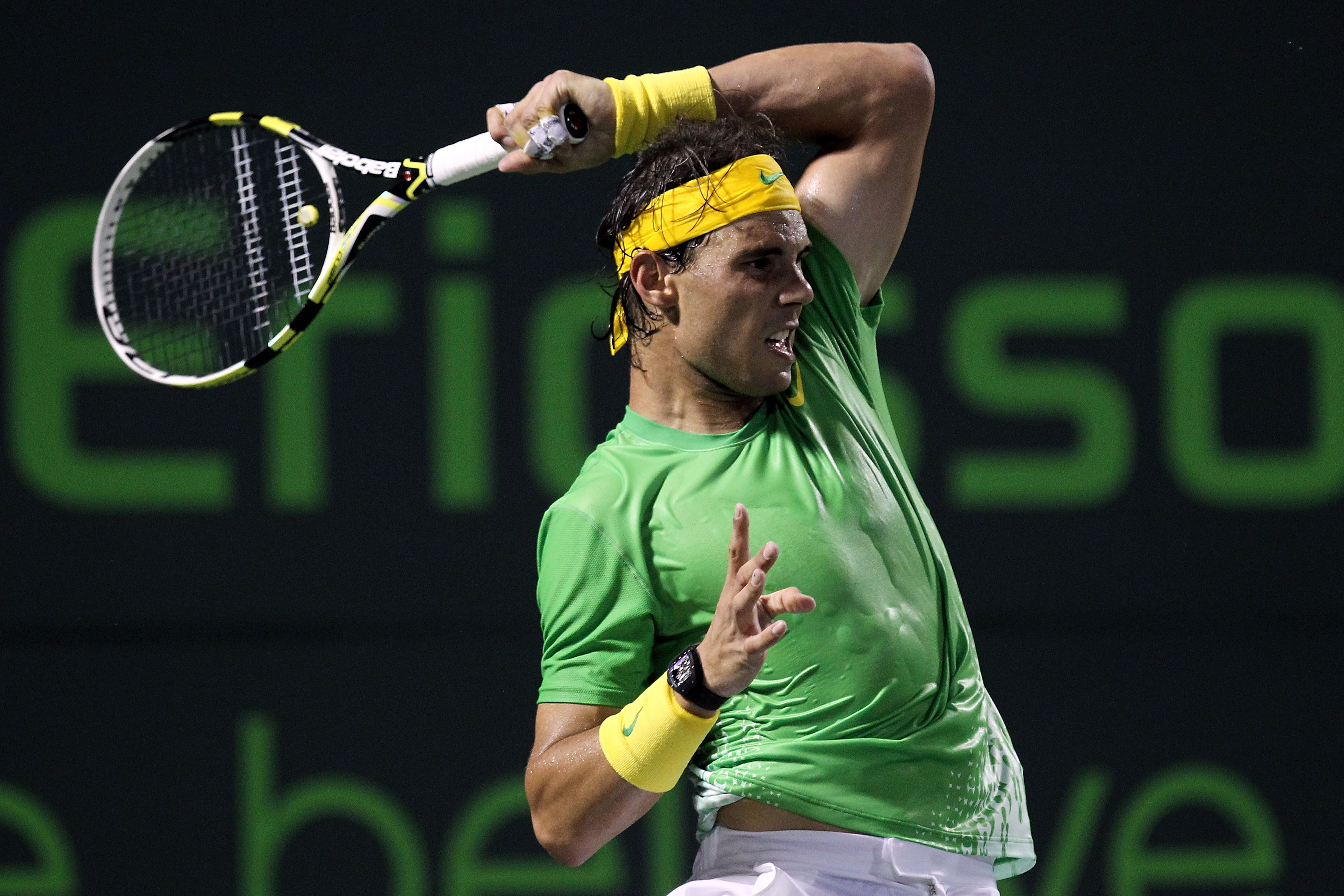 KEY BISCAYNE, FL - APRIL 01:  Rafael Nadal of Spain follows through on a return against Roger Federer of Switzerland during their men's semifinal singles match at the Sony Ericsson Open at Crandon Park Tennis Center on April 1, 2011 in Key Biscayne, Flori